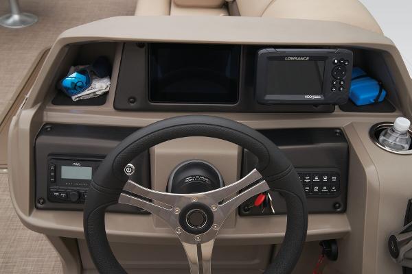 Dashboard of 2024 Sun Tracker Sportfish 24 XP3 with steering wheel and Lowrance fishfinder.