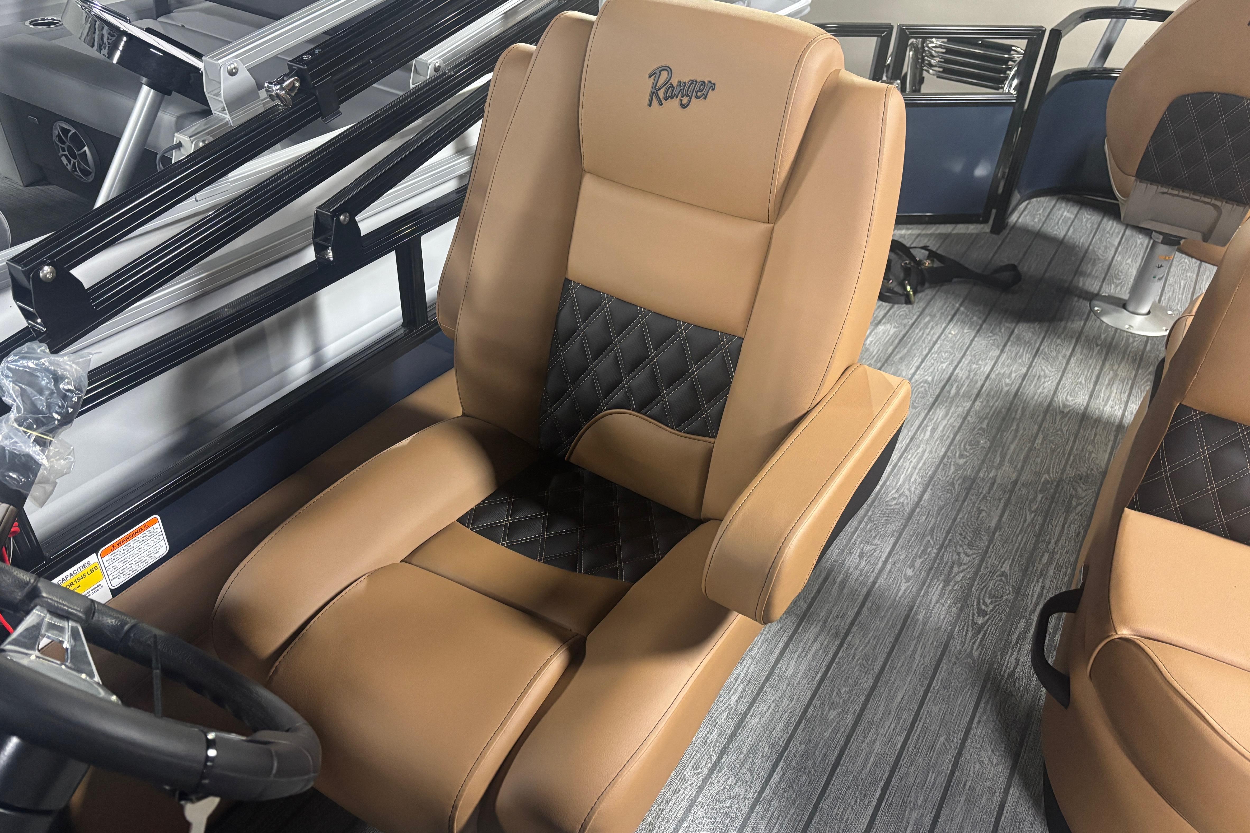 Luxurious tan and black seating in 2026 Ranger 223F boat interior.