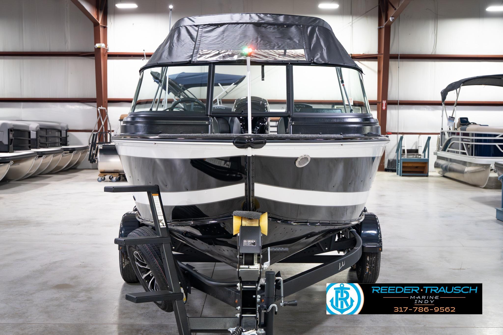 2026 Lund 1875 Impact XS SS boat in showroom, front view with trailer.