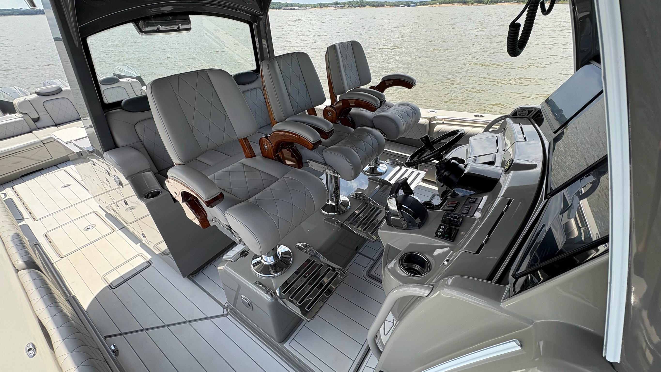 Luxurious 2021 HCB 53 boat interior with plush seating and advanced control panel.