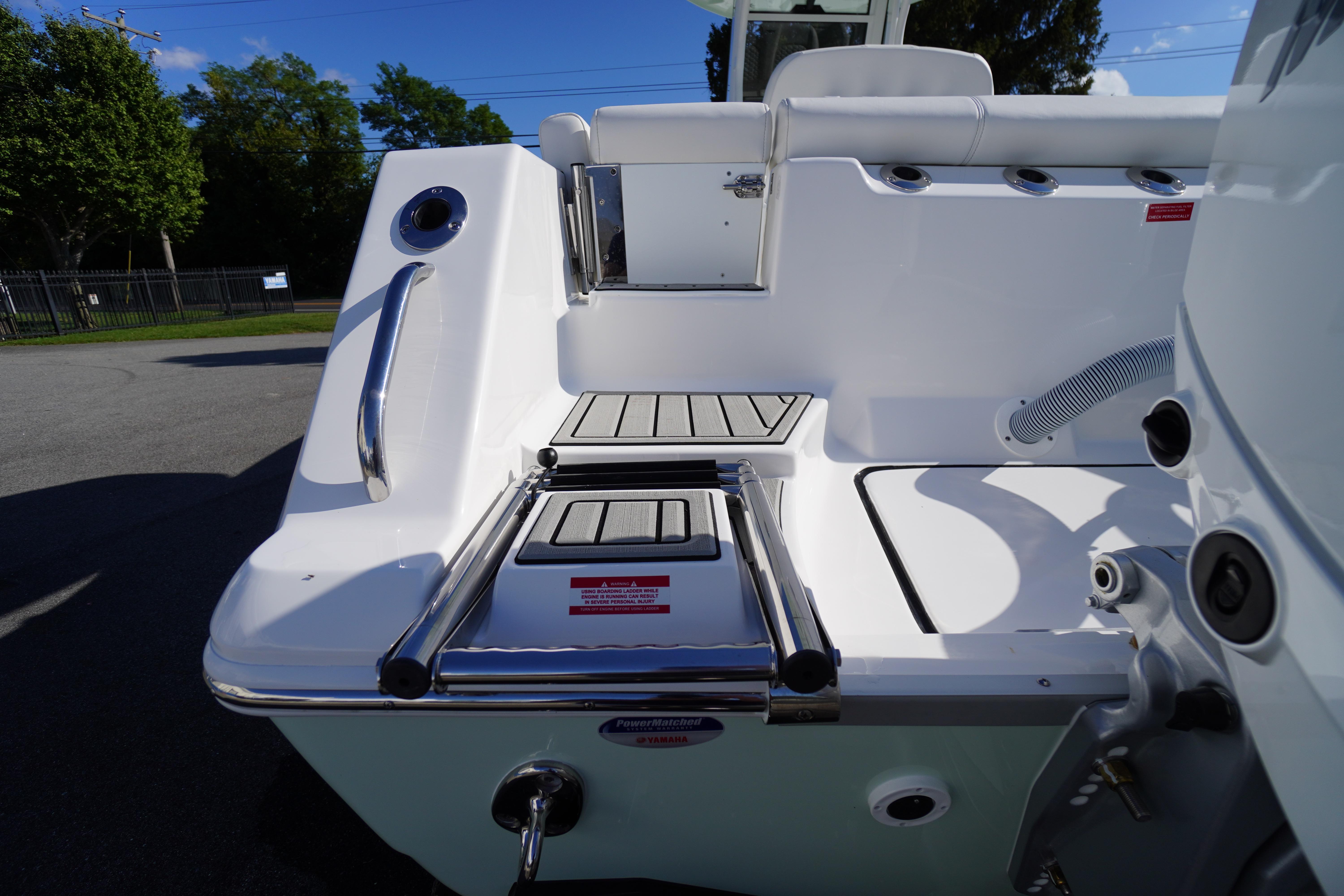 2026 Tidewater 272 LXF boat stern with swim platform and ladder.