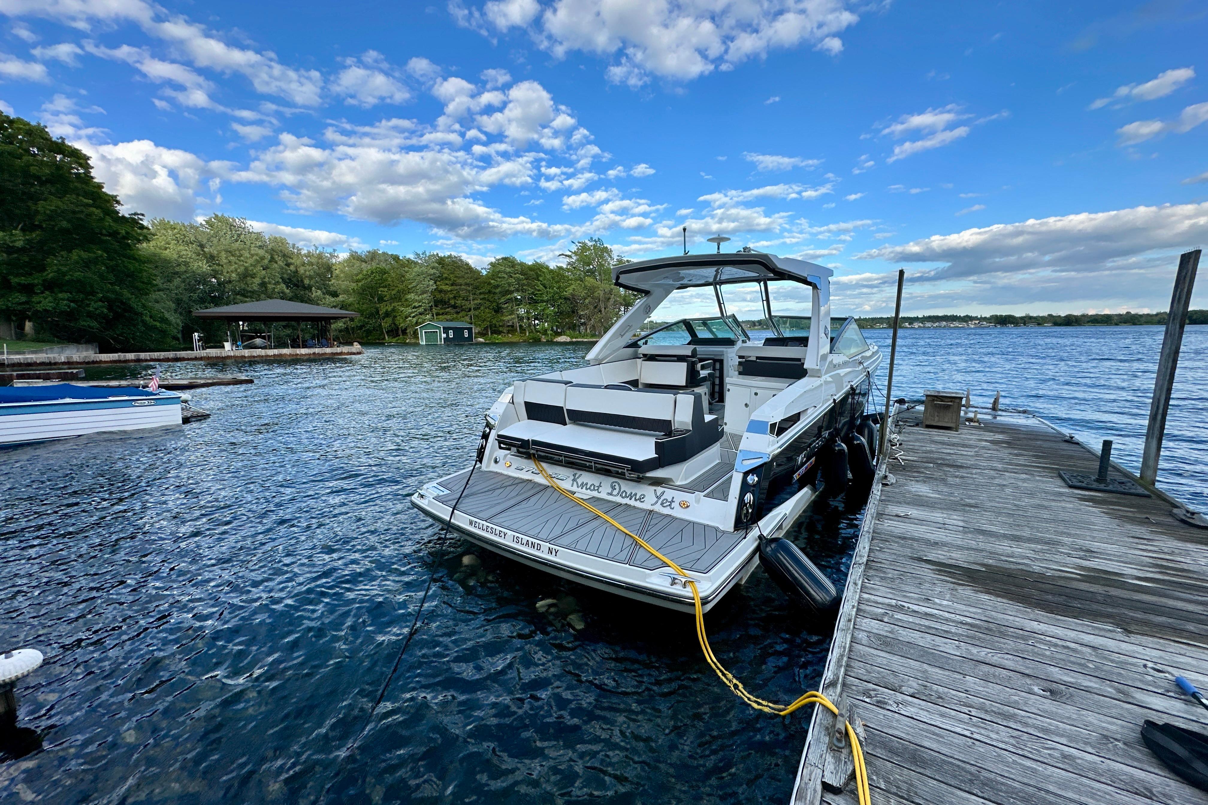 2022 Monterey 378SS Super Sport docked on a scenic lake under a blue sky.