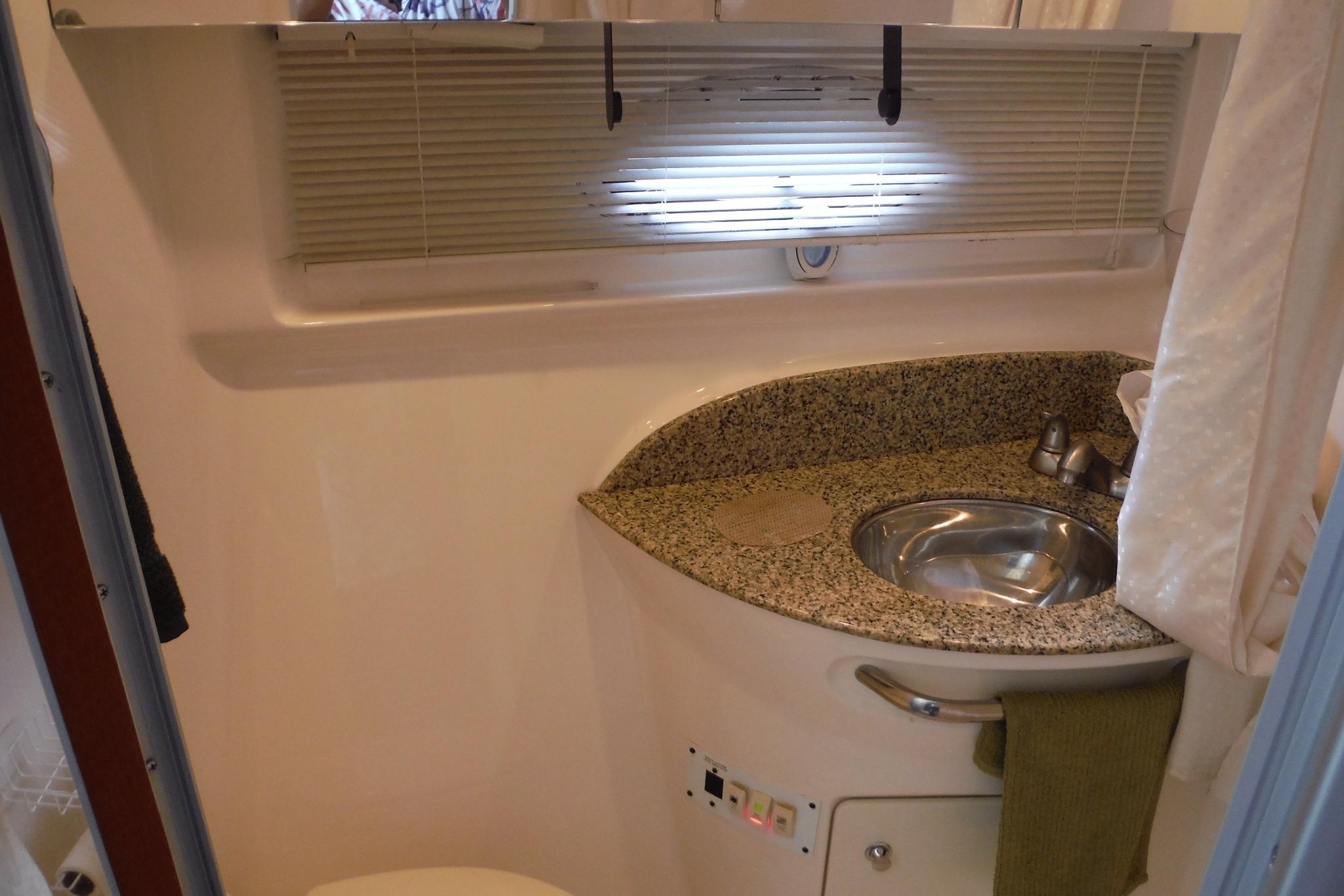 2005 Chaparral Signature 350 bathroom with granite countertop and stainless steel sink.