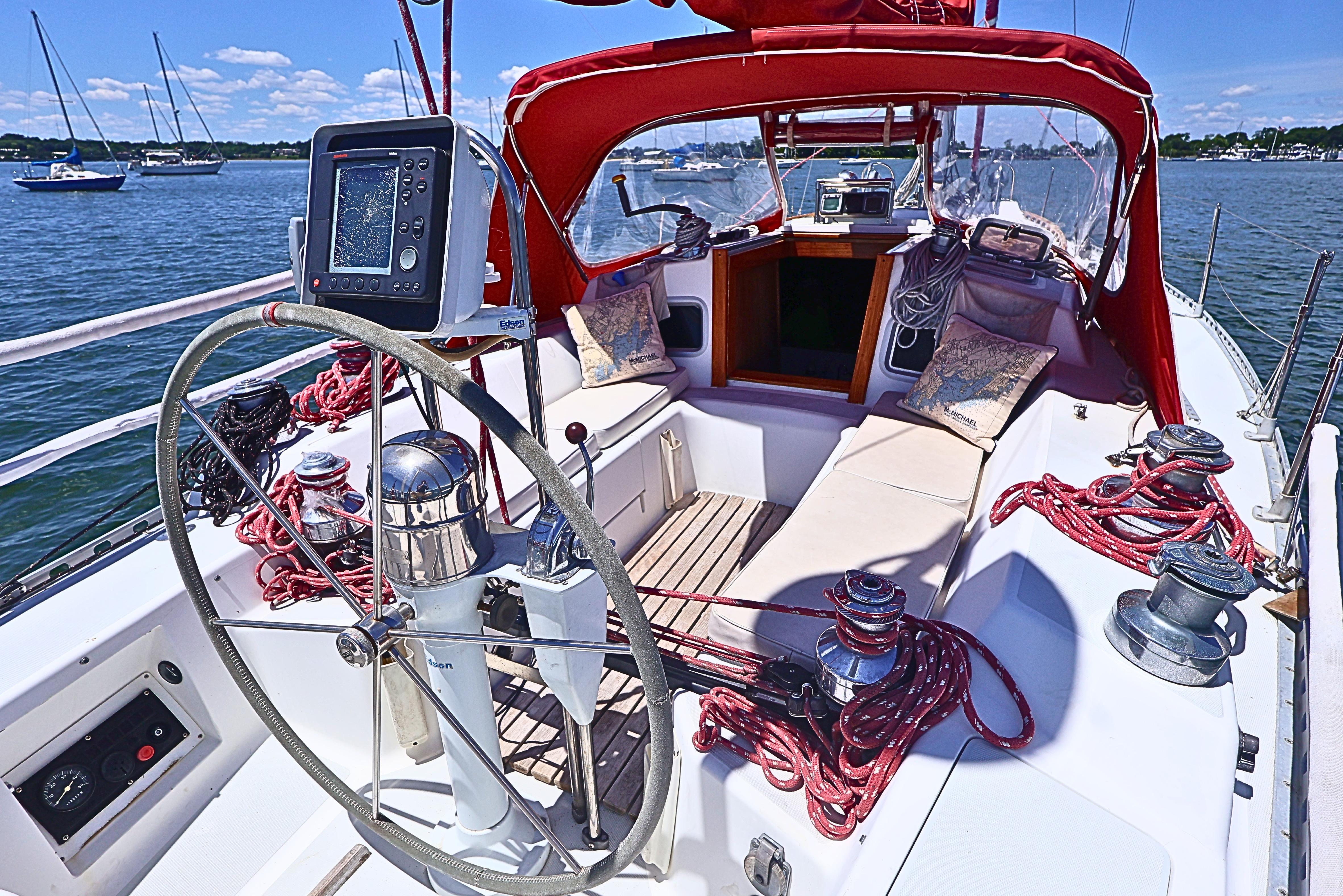 Cockpit of 1989 J Boat J 40 sailboat with red canopy and navigation equipment.