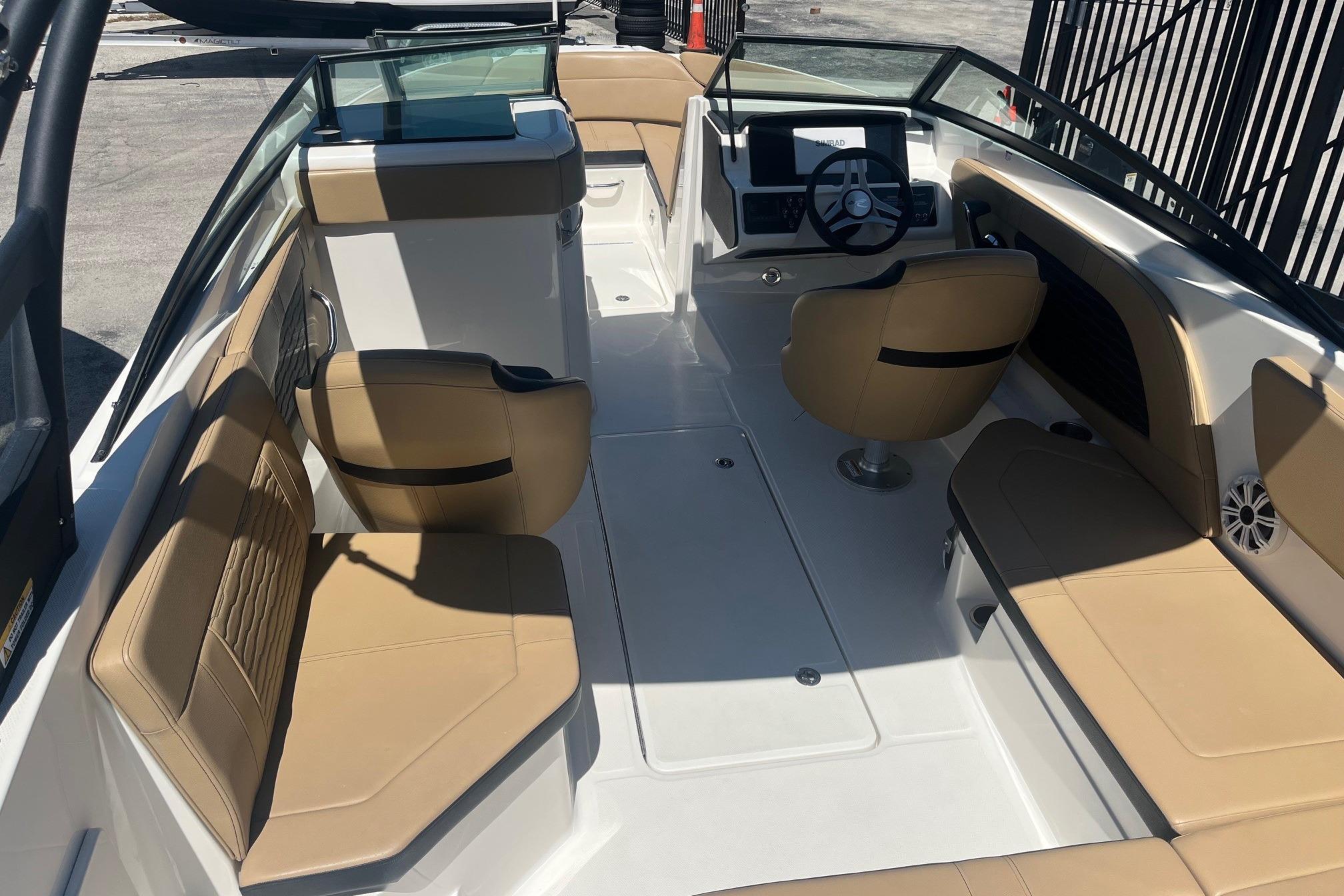 2024 Sea Ray SPX 230 boat interior with tan seating and modern dashboard.
