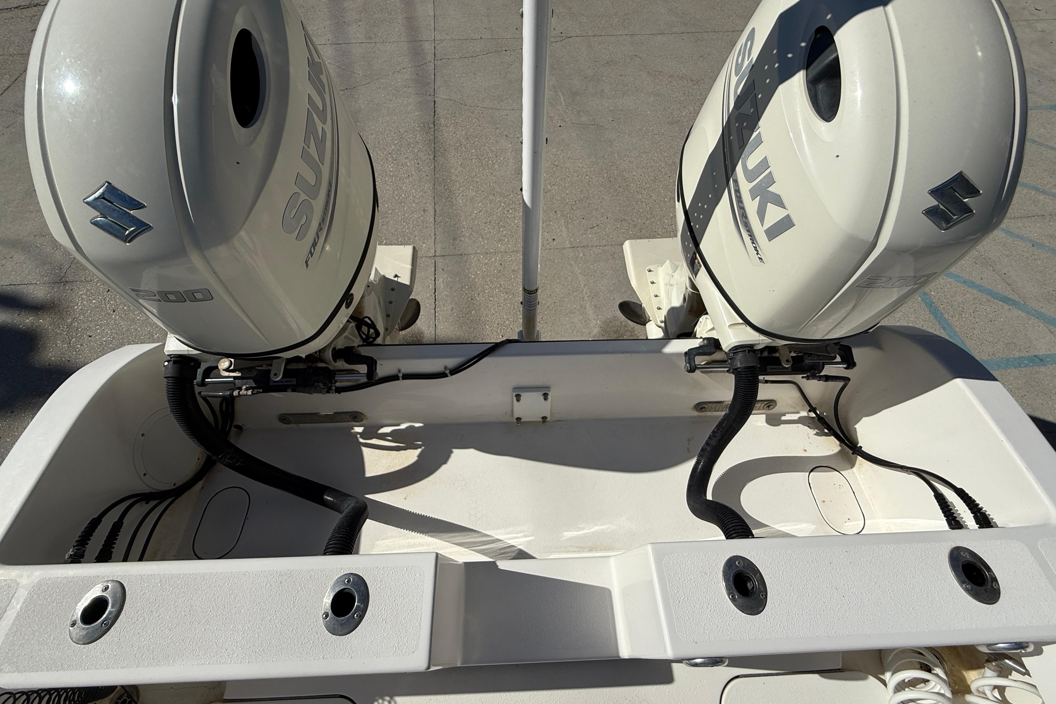 2020 Tideline 235 Hybrid boat with dual Suzuki outboard engines.