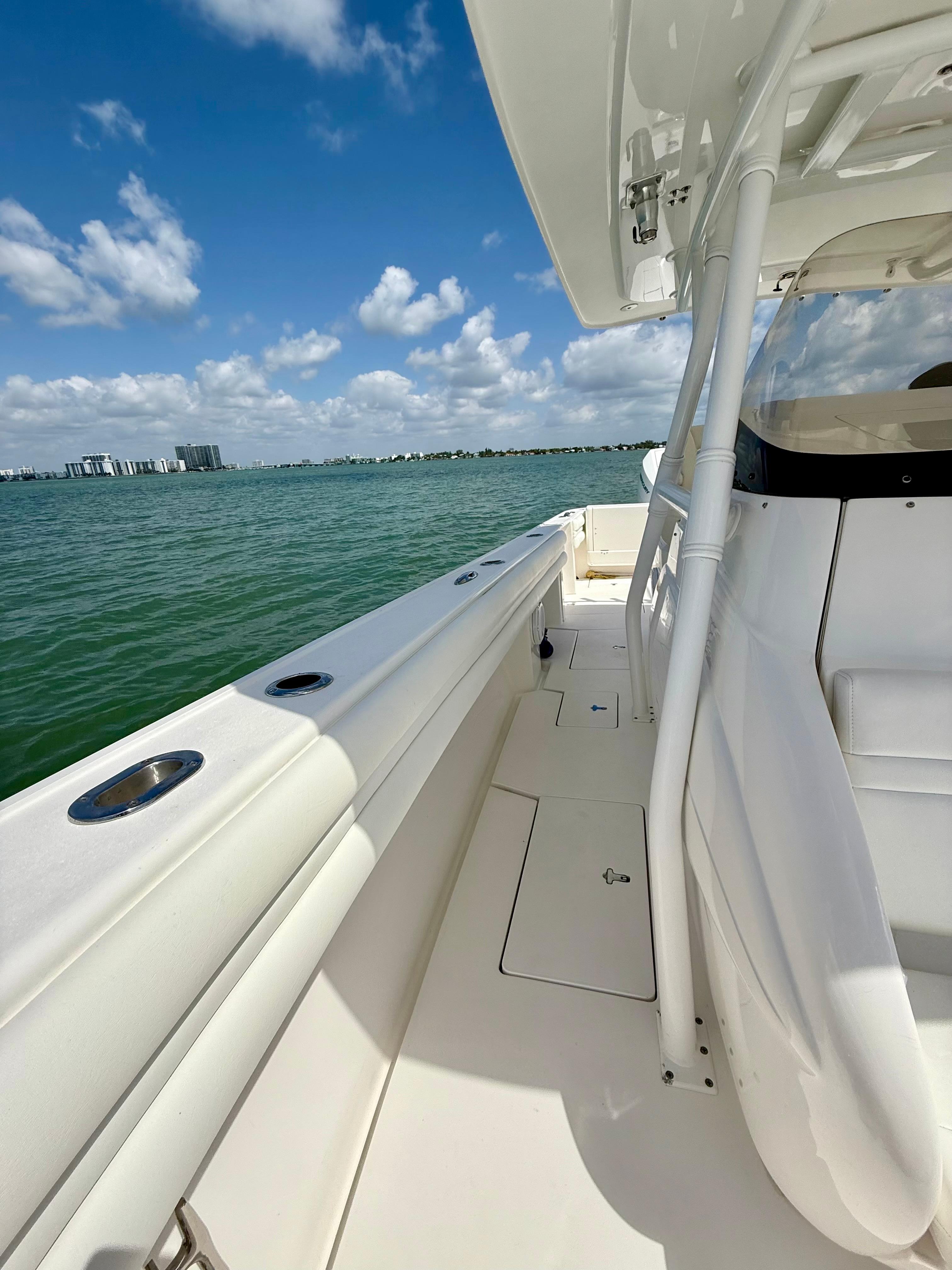 2015 Intrepid 375 Center Console boat on calm water under a clear blue sky.