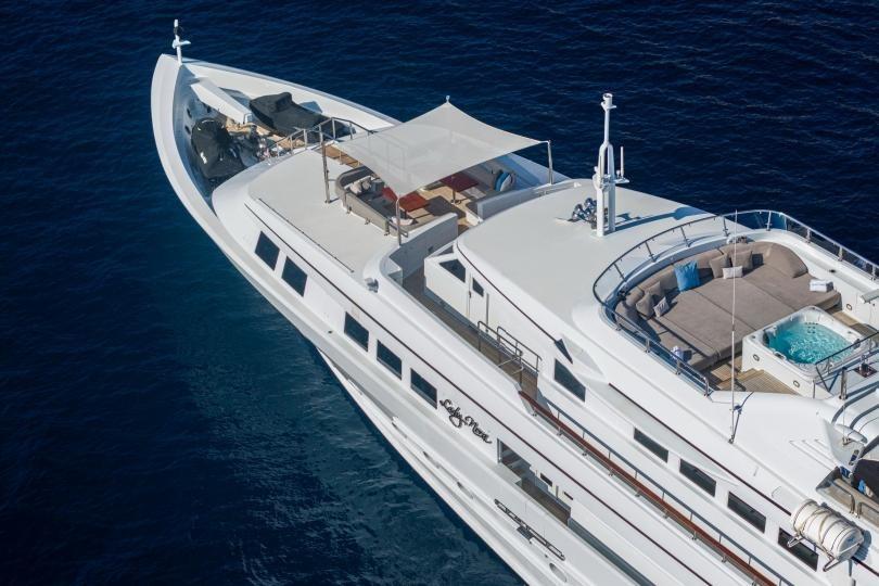 Luxurious 1998 Absolute Semi Displacement yacht with spacious deck and jacuzzi on open sea.