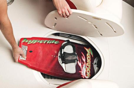 Storing a wakeboard in a 2012 Tahoe Q4 SS boat compartment.