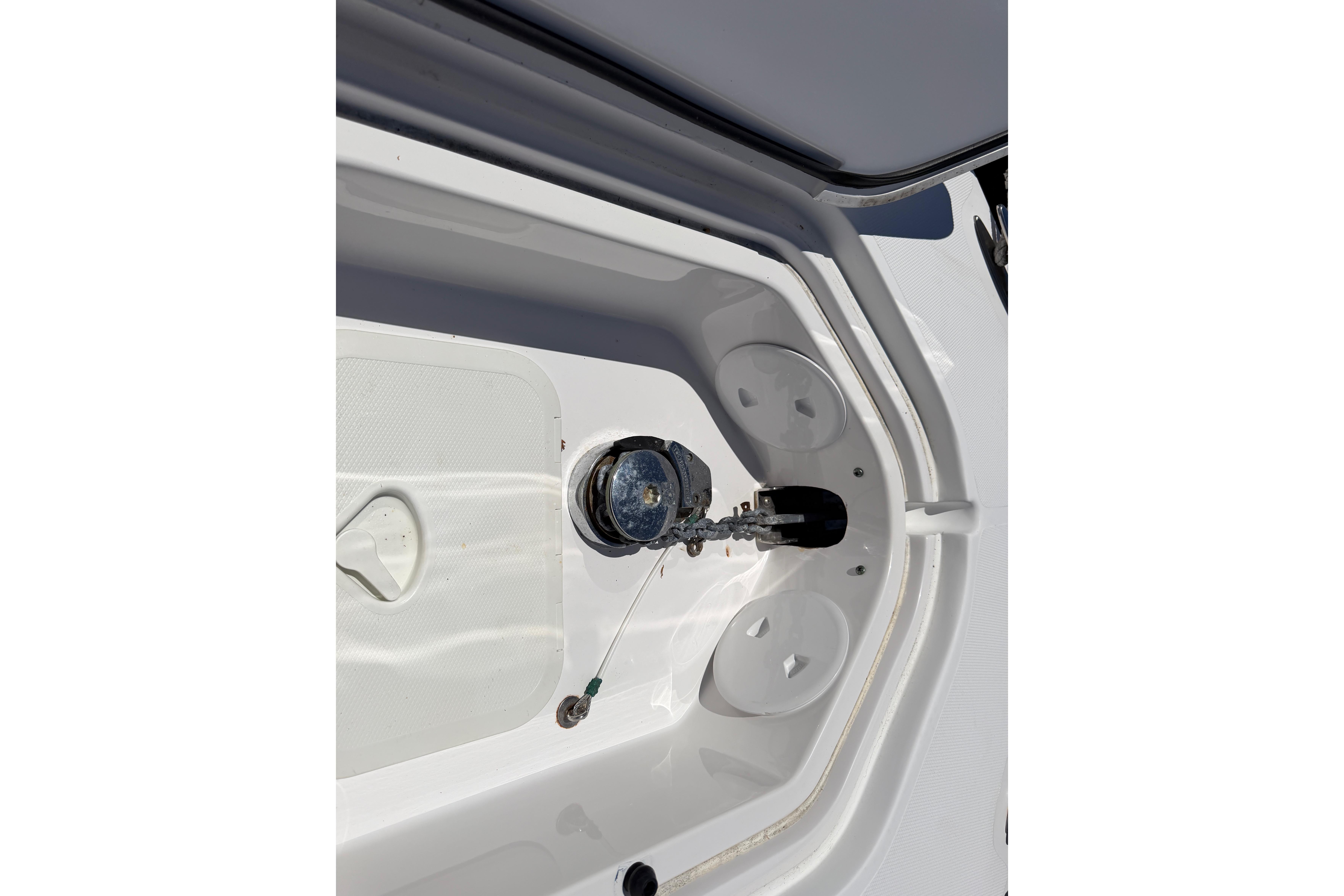 Anchor compartment of a 2006 Southport 26 Center Console boat, showcasing storage details.