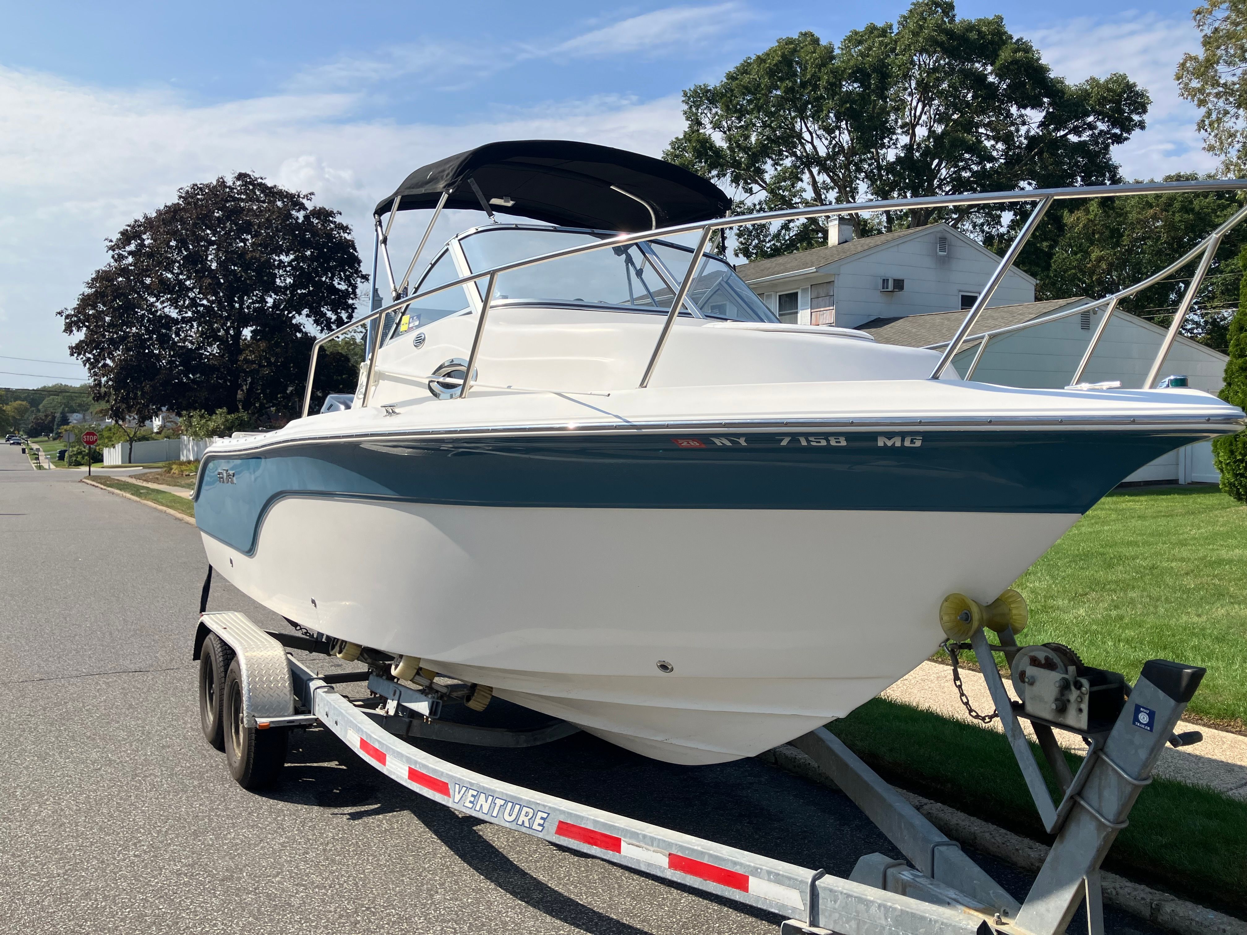 Custom 216wa pro boat from 2010 on trailer in residential area.