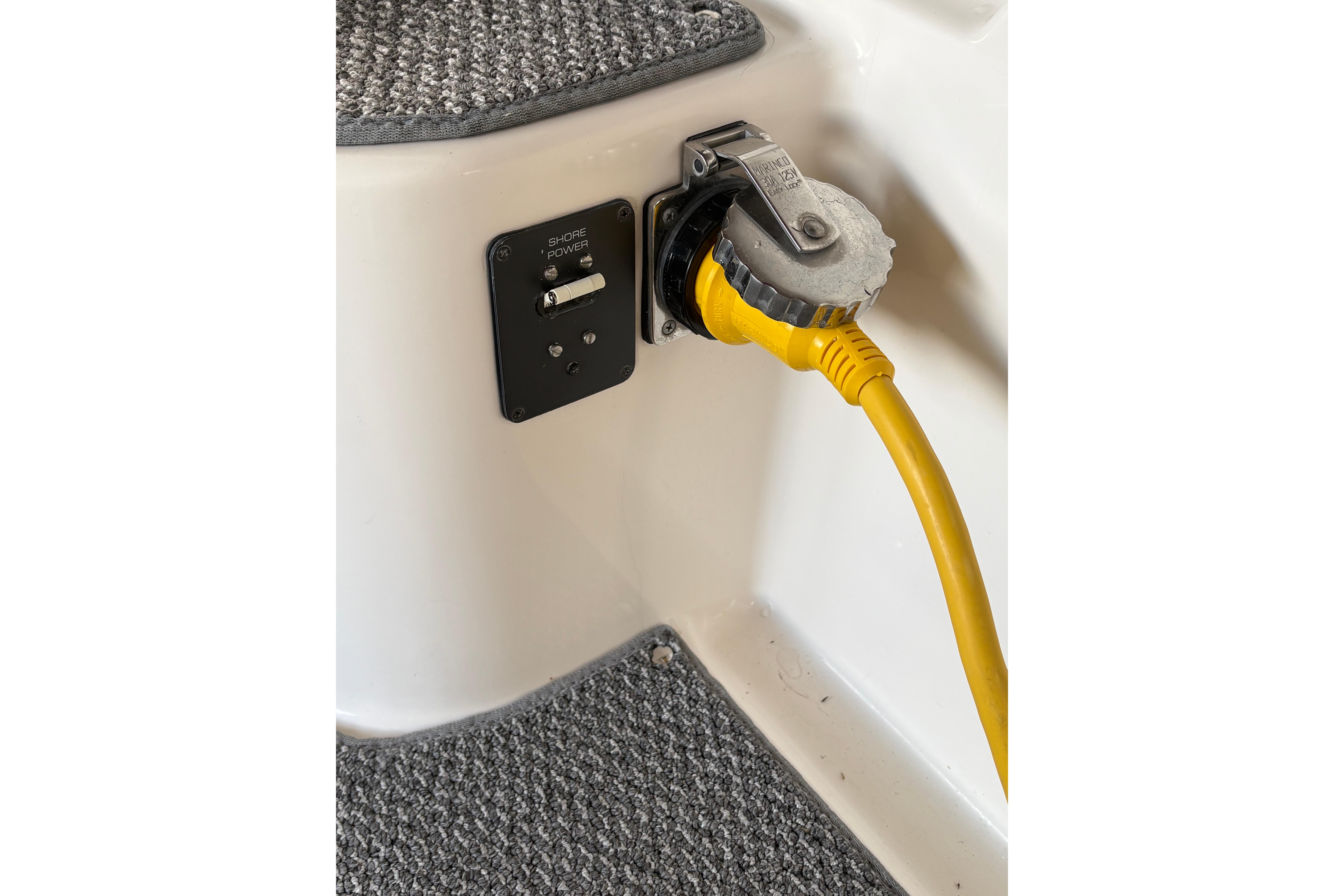Shore power connection on 1999 Tiara Yachts 3100 Open with yellow cable.