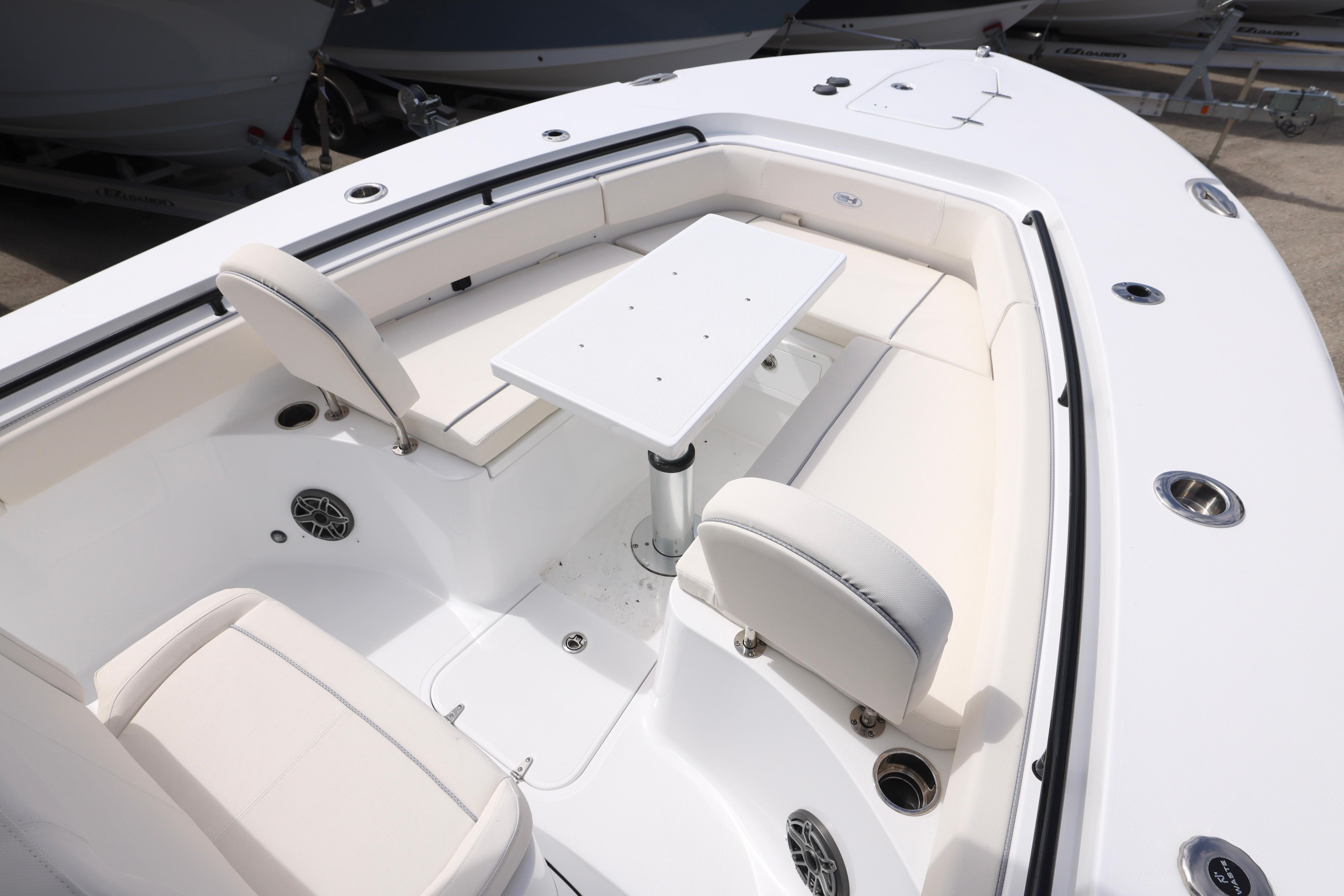 2026 Sea Hunt Gamefish 25 boat interior with seating and table, showcasing modern design.