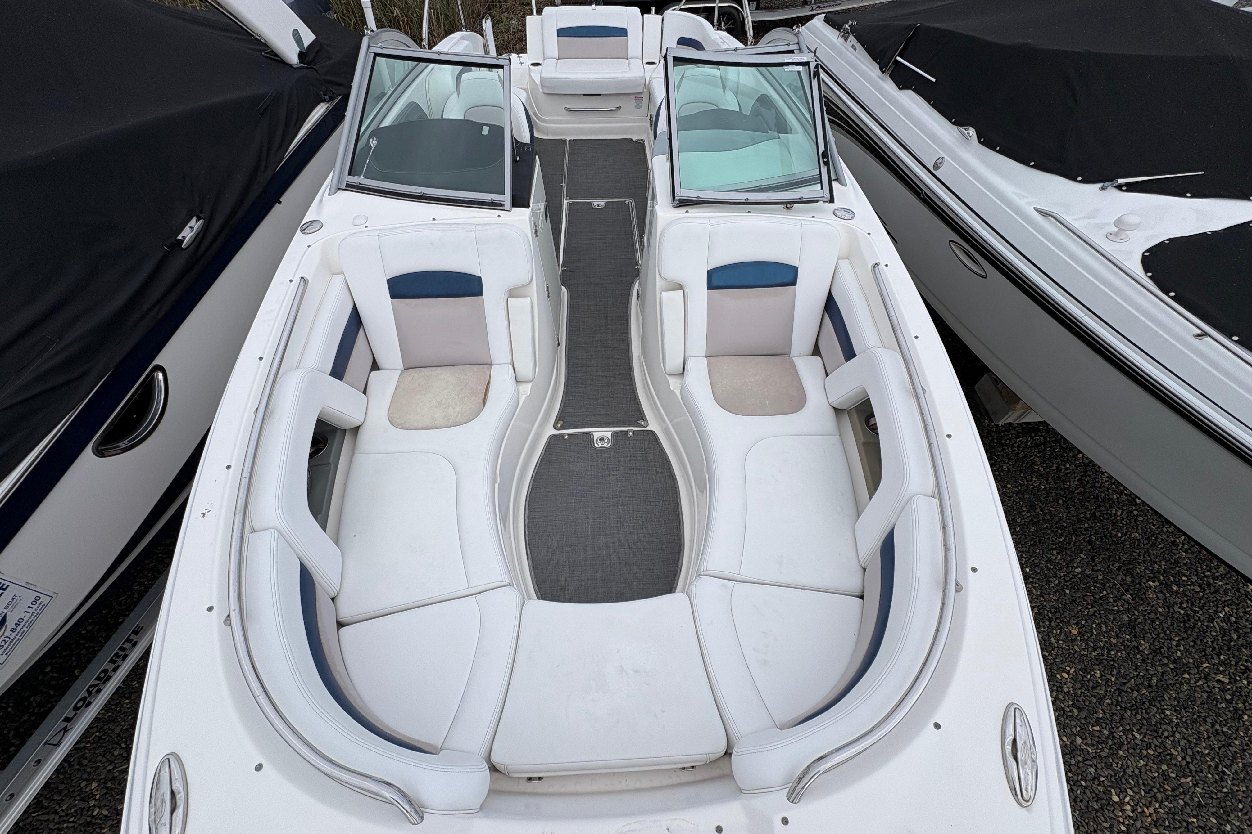 2015 Chaparral 264 Sunesta boat with spacious seating and sleek design.