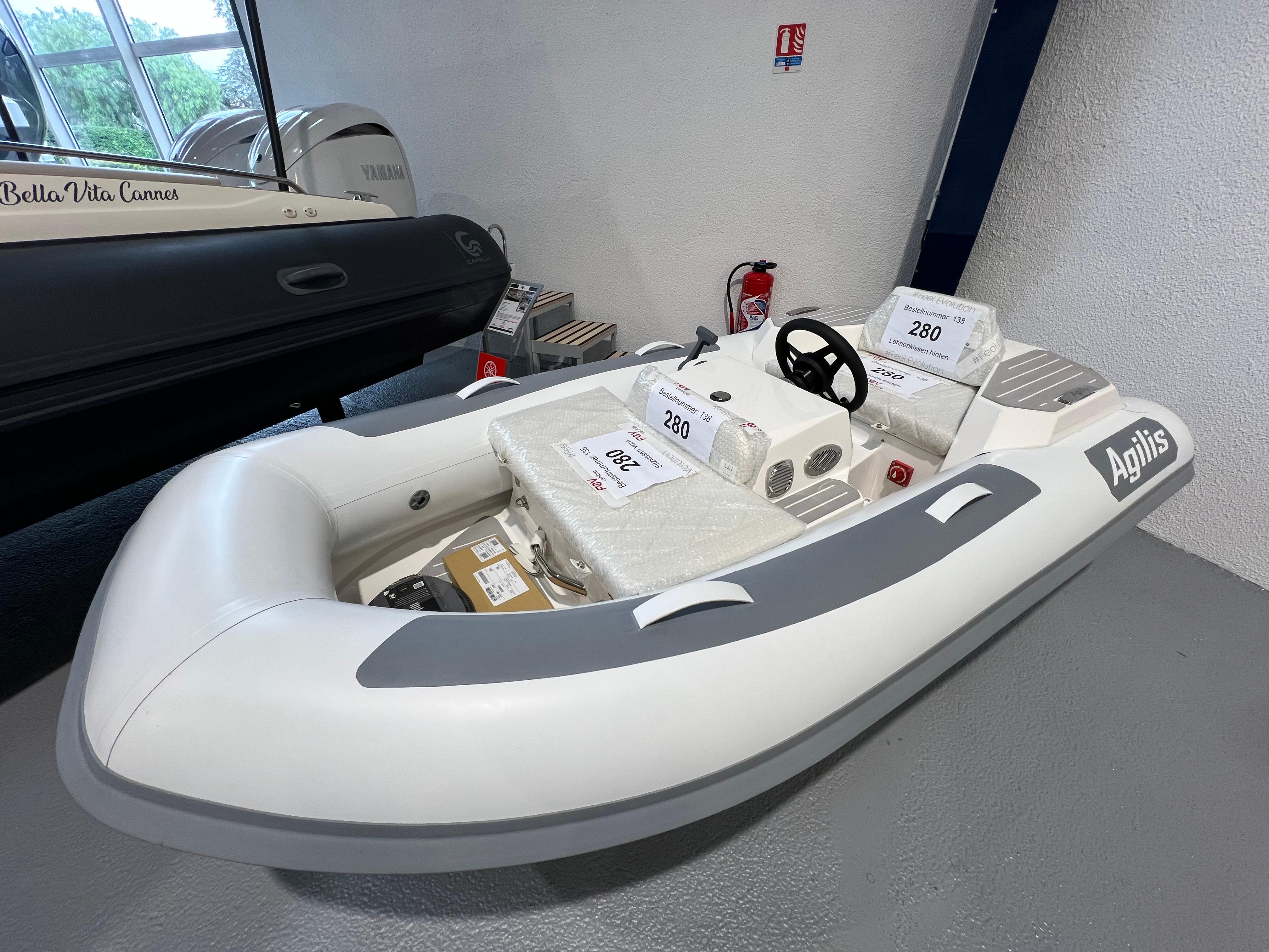 2025 Agilis 280 inflatable boat displayed indoors, featuring a sleek white and gray design.