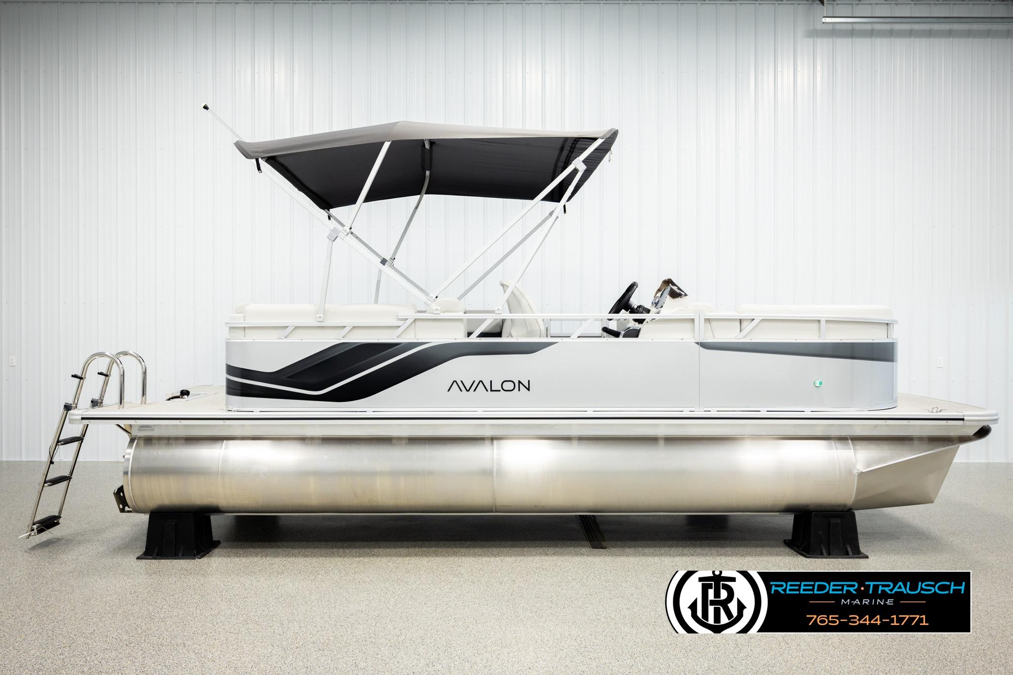 2026 Avalon VLS QL pontoon boat with canopy in showroom, side view.