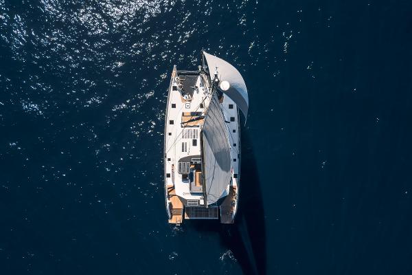 Aerial view of 2025 Privilege Signature 650 yacht sailing on deep blue ocean.