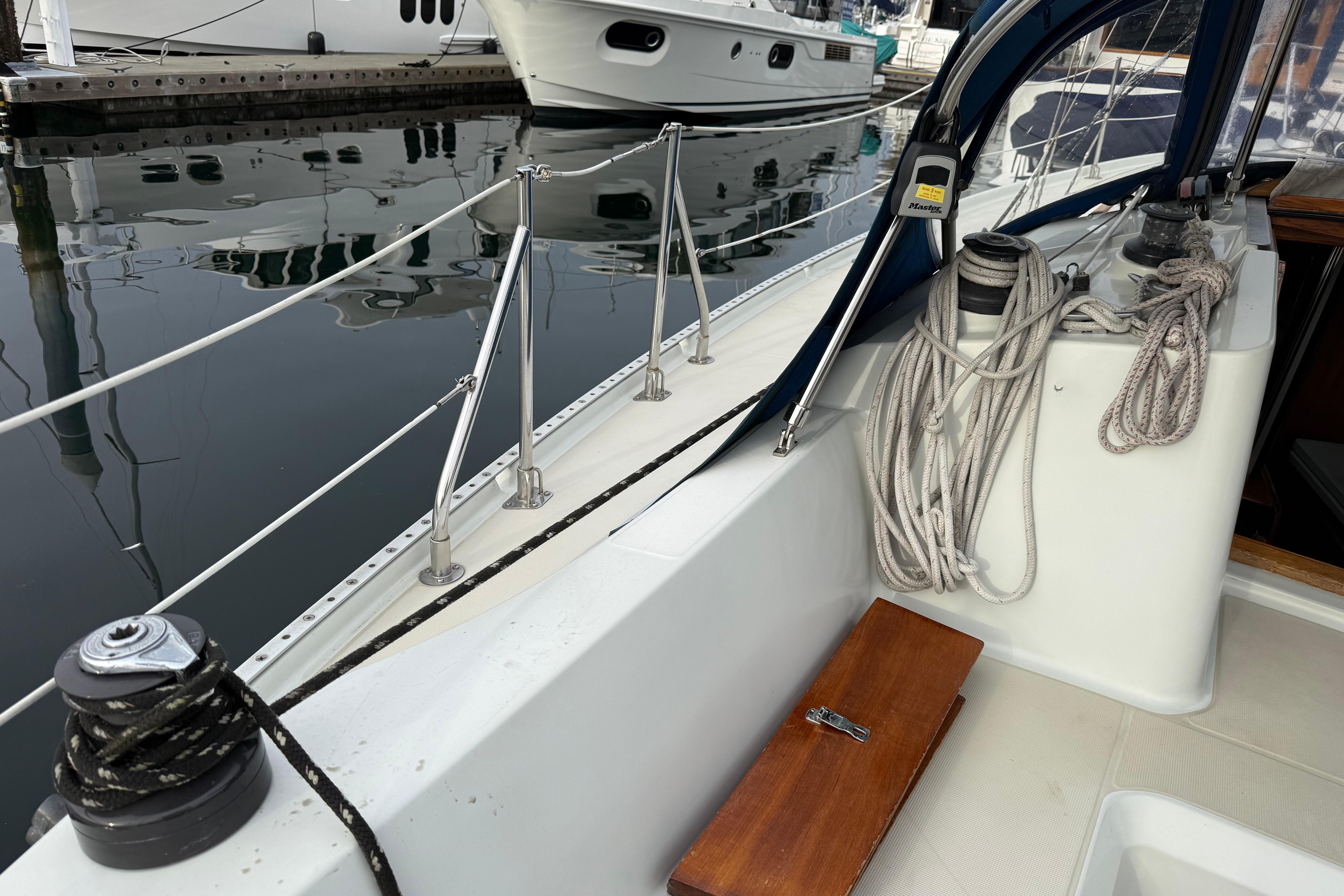 1988 Ericson 32-200 sailboat deck with ropes and winches at marina.