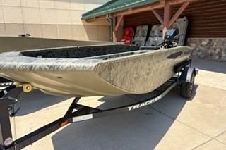 2025 Tracker Grizzly 1650 T Prairie Wings Edition boat on trailer, outdoors.