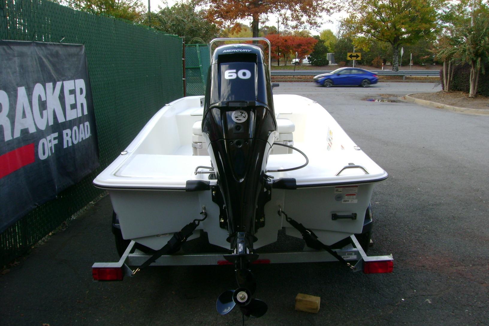 2026 Mako Pro Skiff 15 CC boat on trailer, parked outdoors.