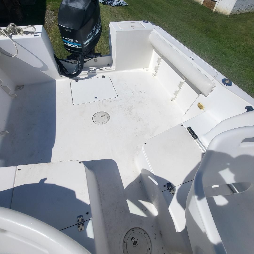 The image shows the cockpit of a 1998 Sport-Craft 211WAC boat with an outboard motor.
