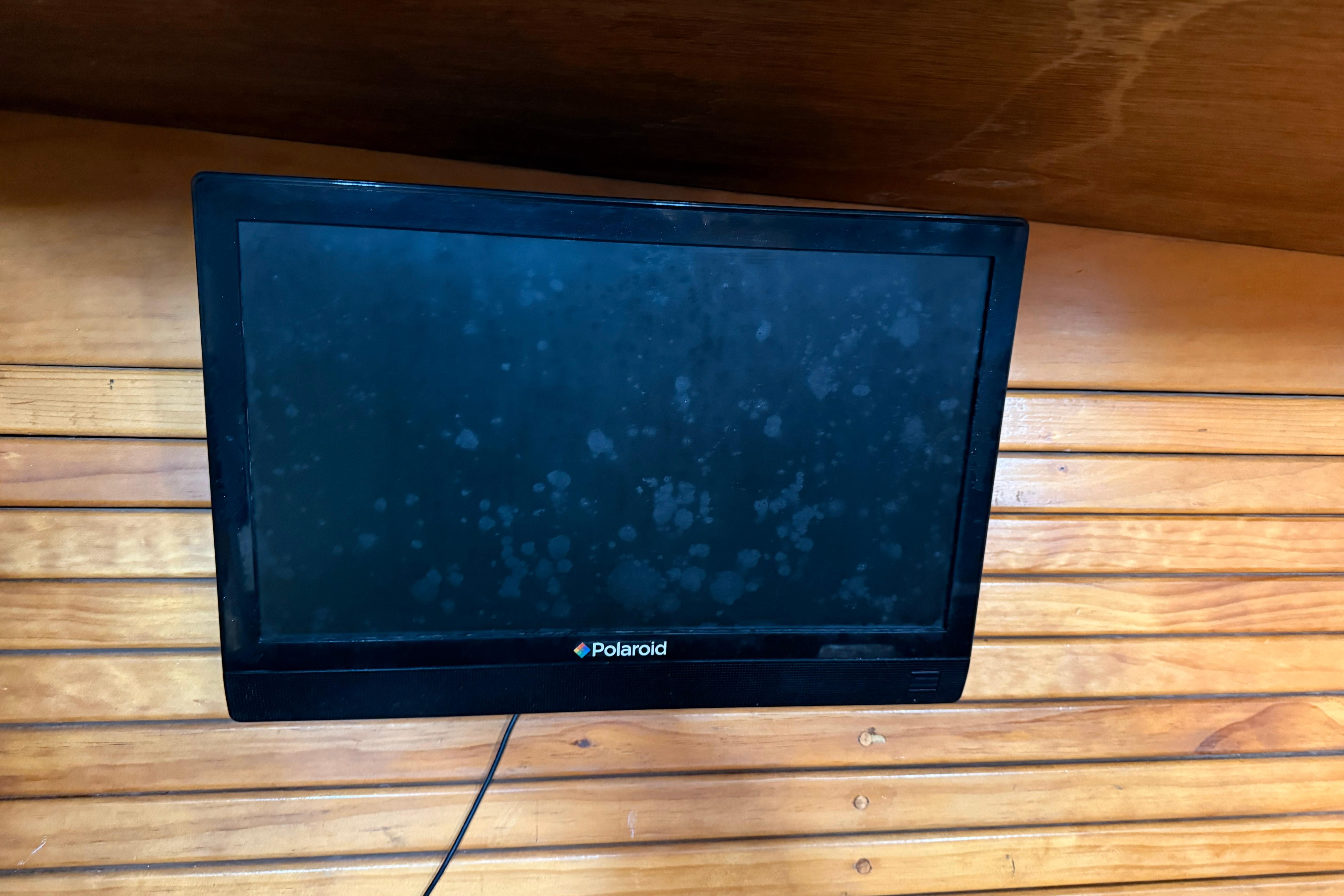 Polaroid TV mounted on wooden wall inside 1992 Treworgy 65 Schooner.