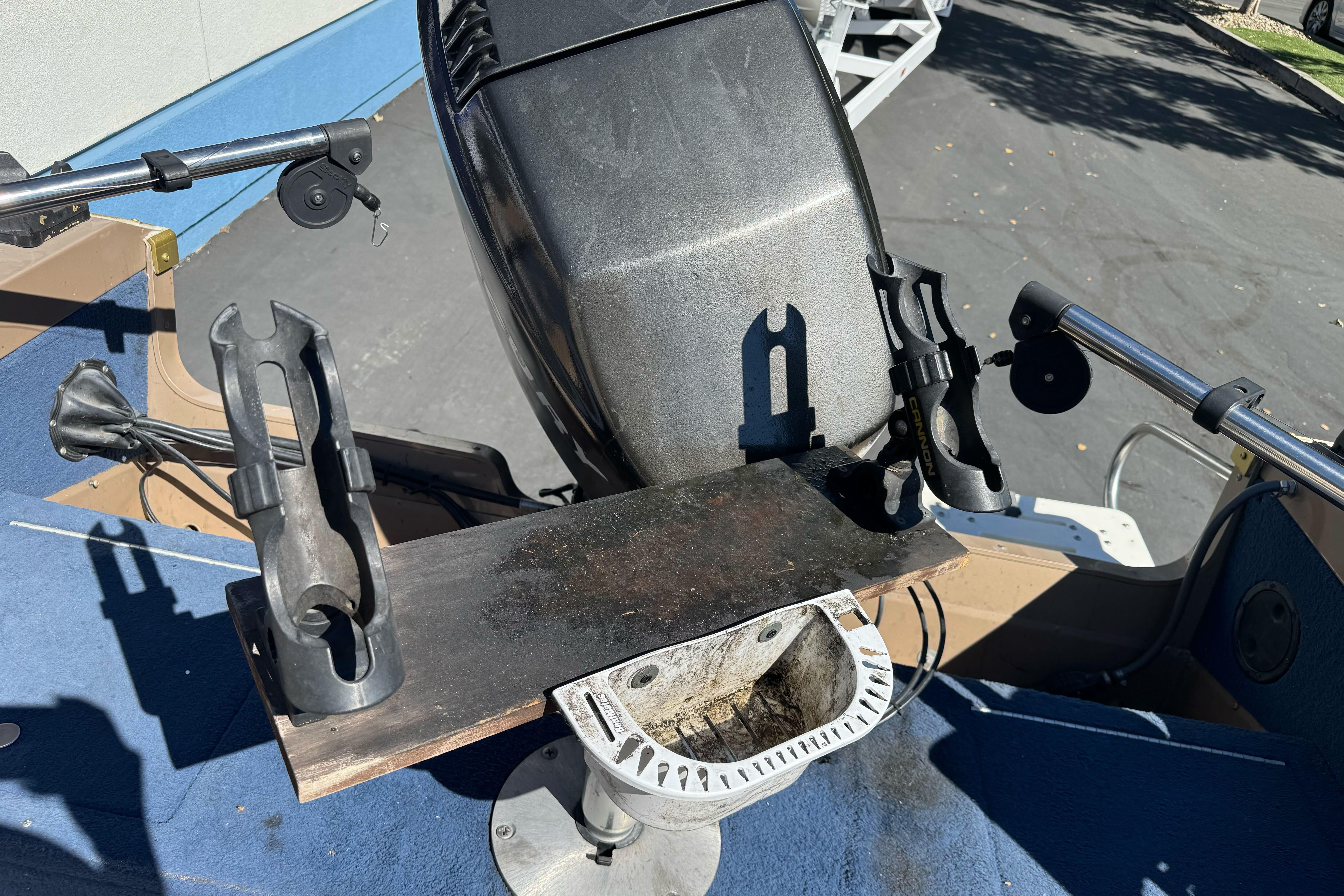 1998 Lund 1700 Pro Sport boat interior with motor and rod holders.