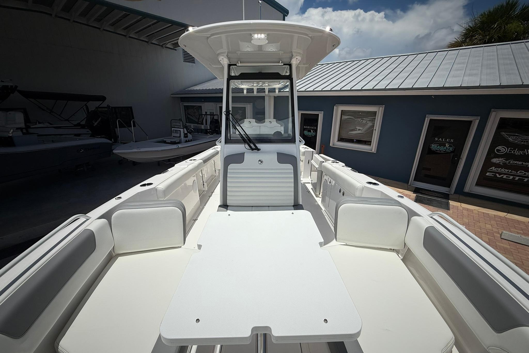 2026 Edgewater 250CC boat interior with seating and helm, displayed outdoors.