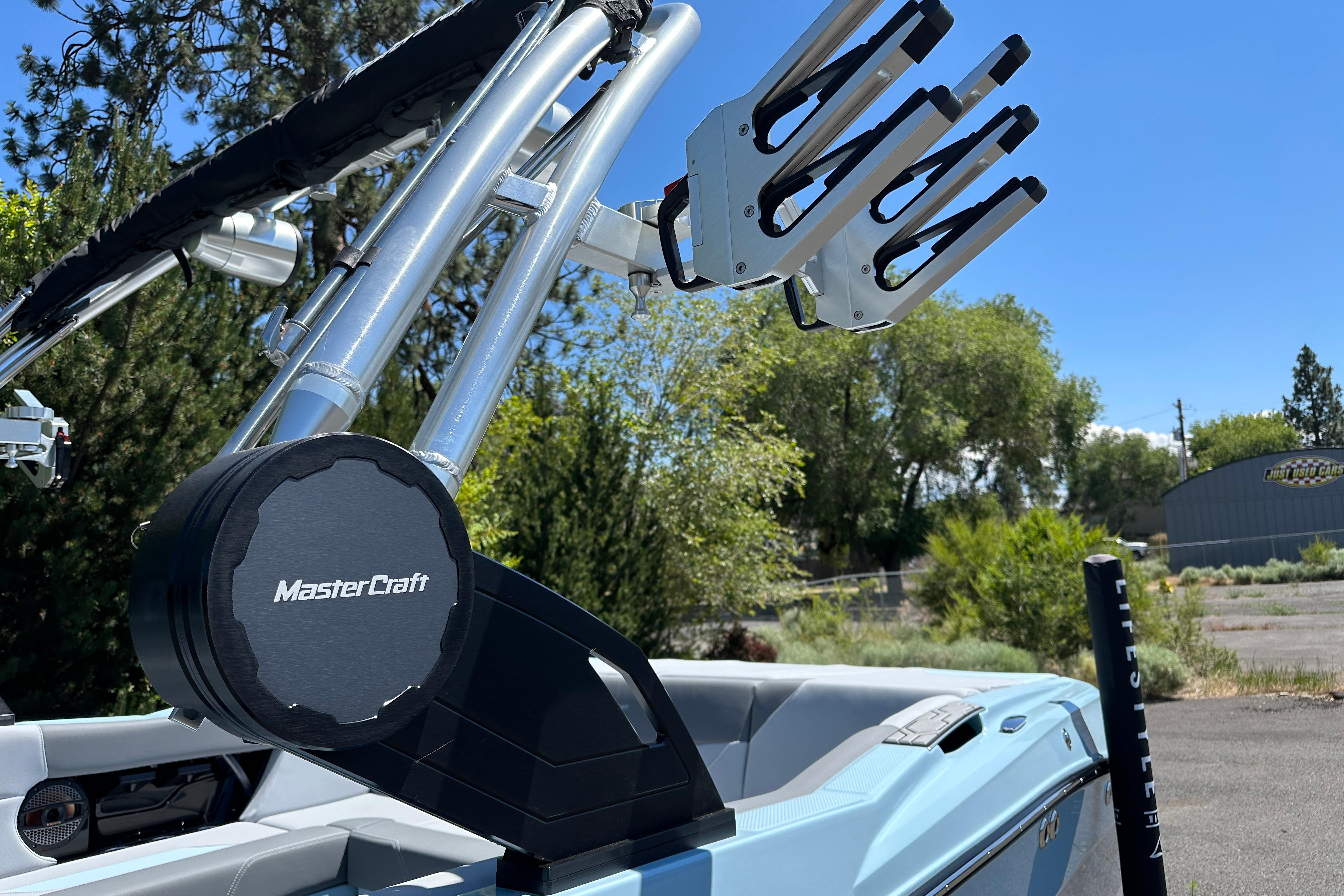 2023 MasterCraft NXT23 boat with wakeboard tower and speaker, outdoors.