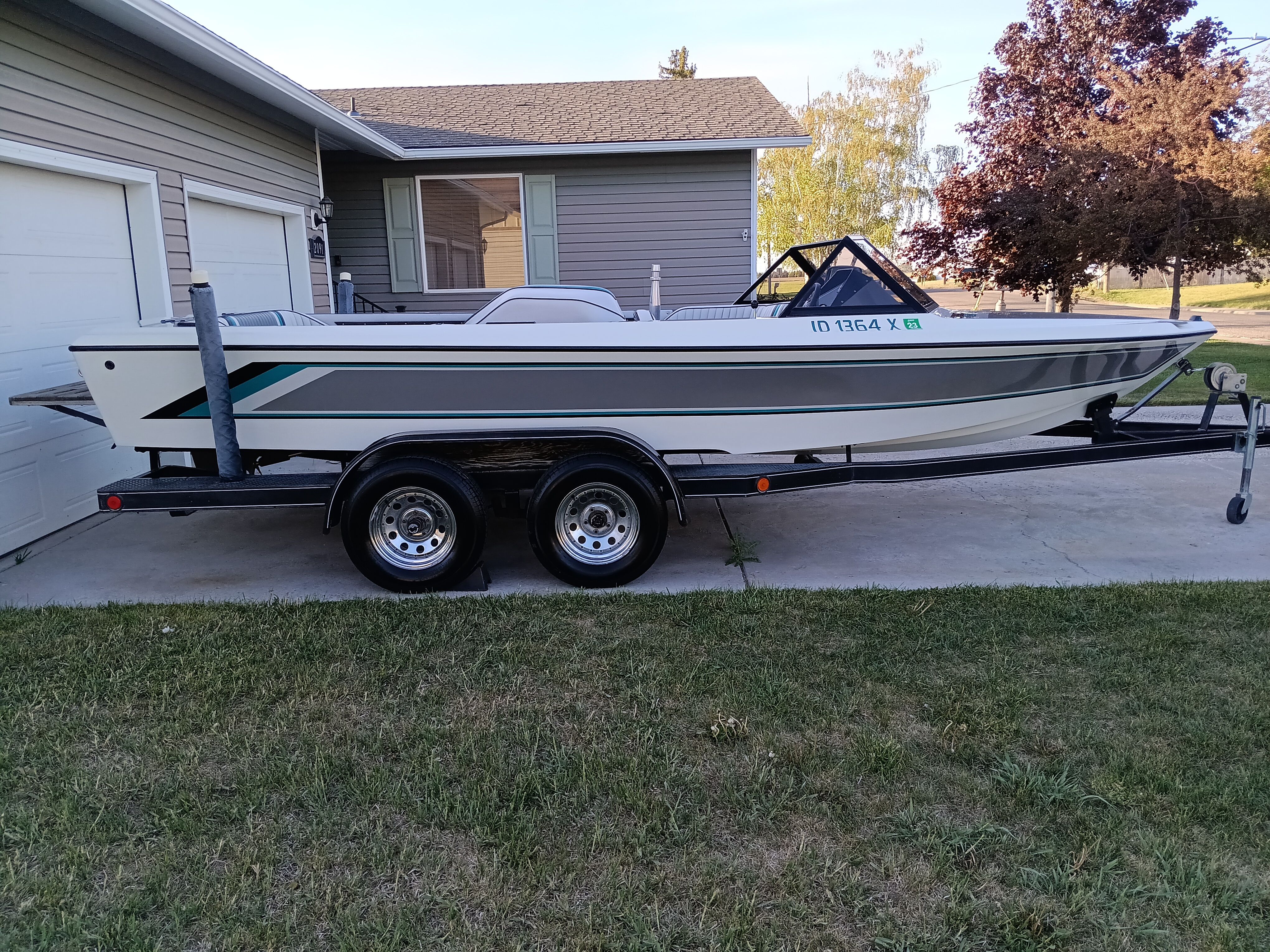 1991 Malibu Skier boat on trailer parked in driveway.