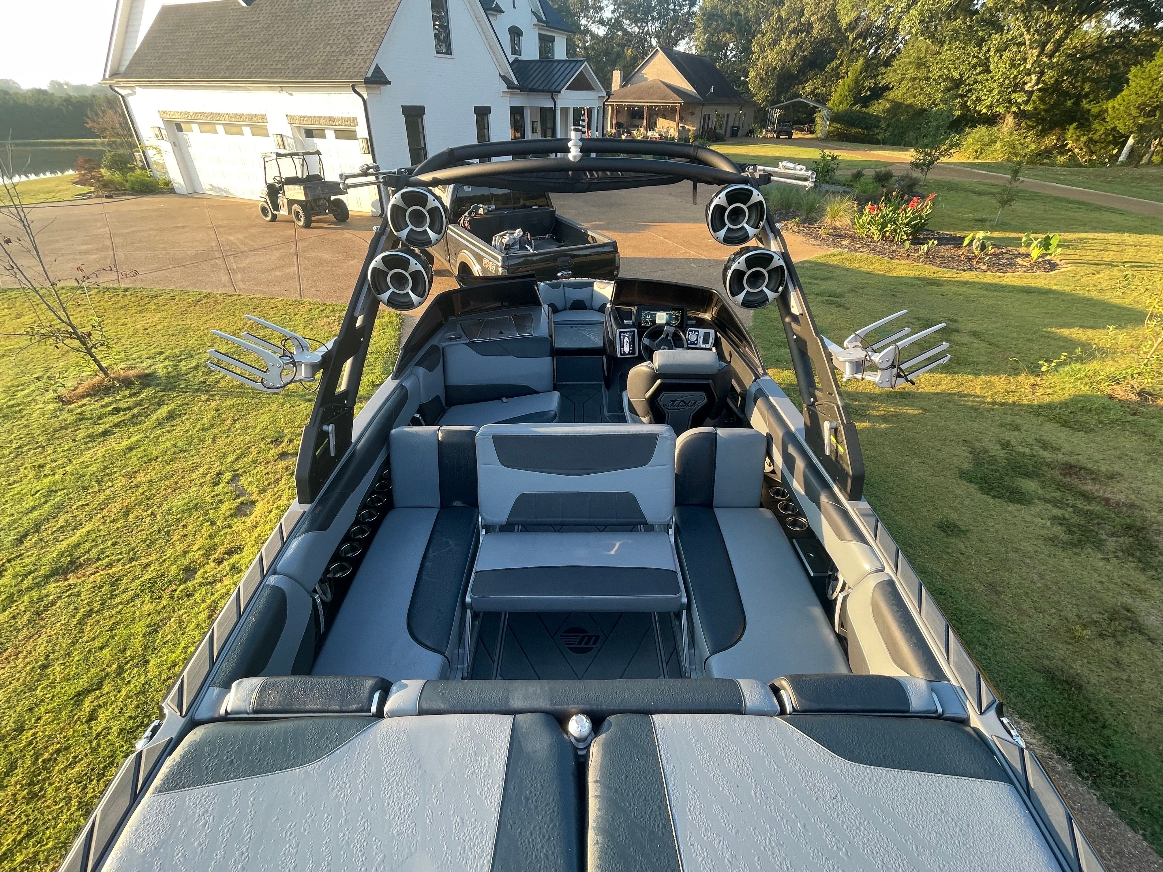 2020 Malibu Wakesetter 23 LSV with gray seating and speakers, parked on a lawn.