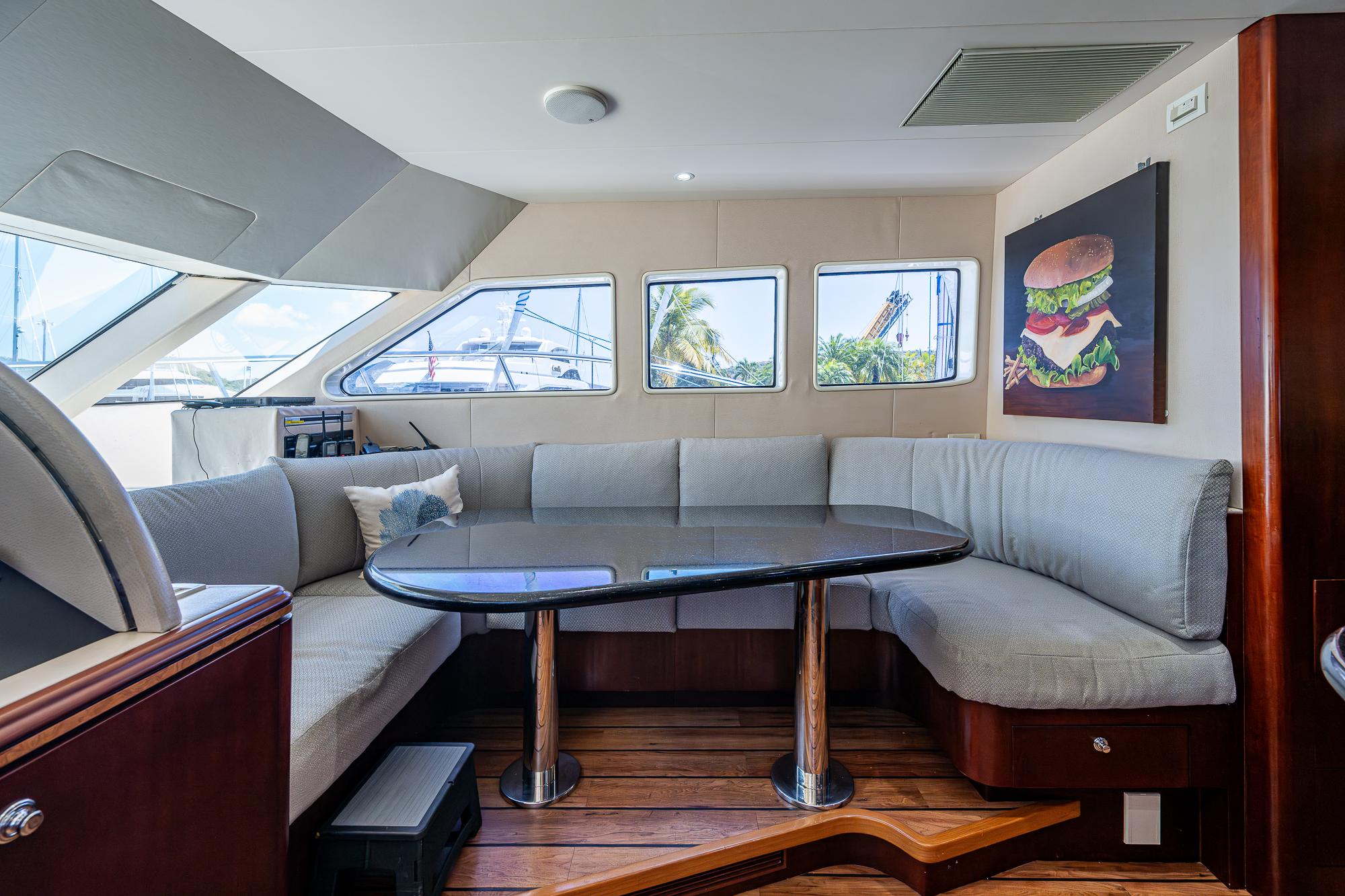 2007 Cheoy Lee Bravo Flybridge Motor Yacht interior with a cozy seating area and dining table.