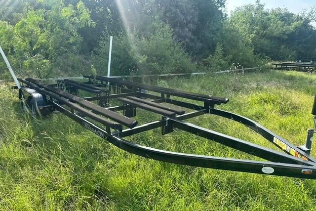 2019 Sun Tracker Party Barge 22 XP3 trailer in grassy outdoor setting.