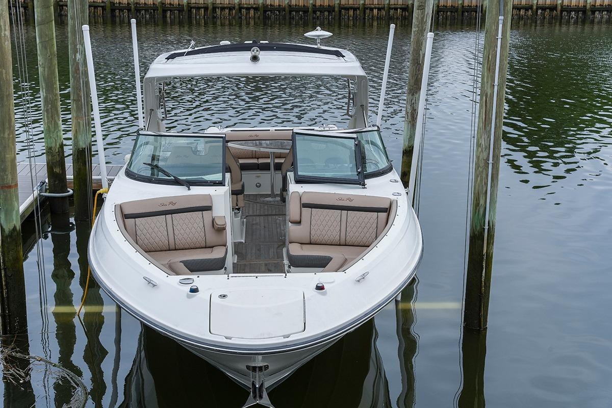 2018 Sea Ray SLX 350 boat docked in calm waters, showcasing luxurious seating and sleek design.