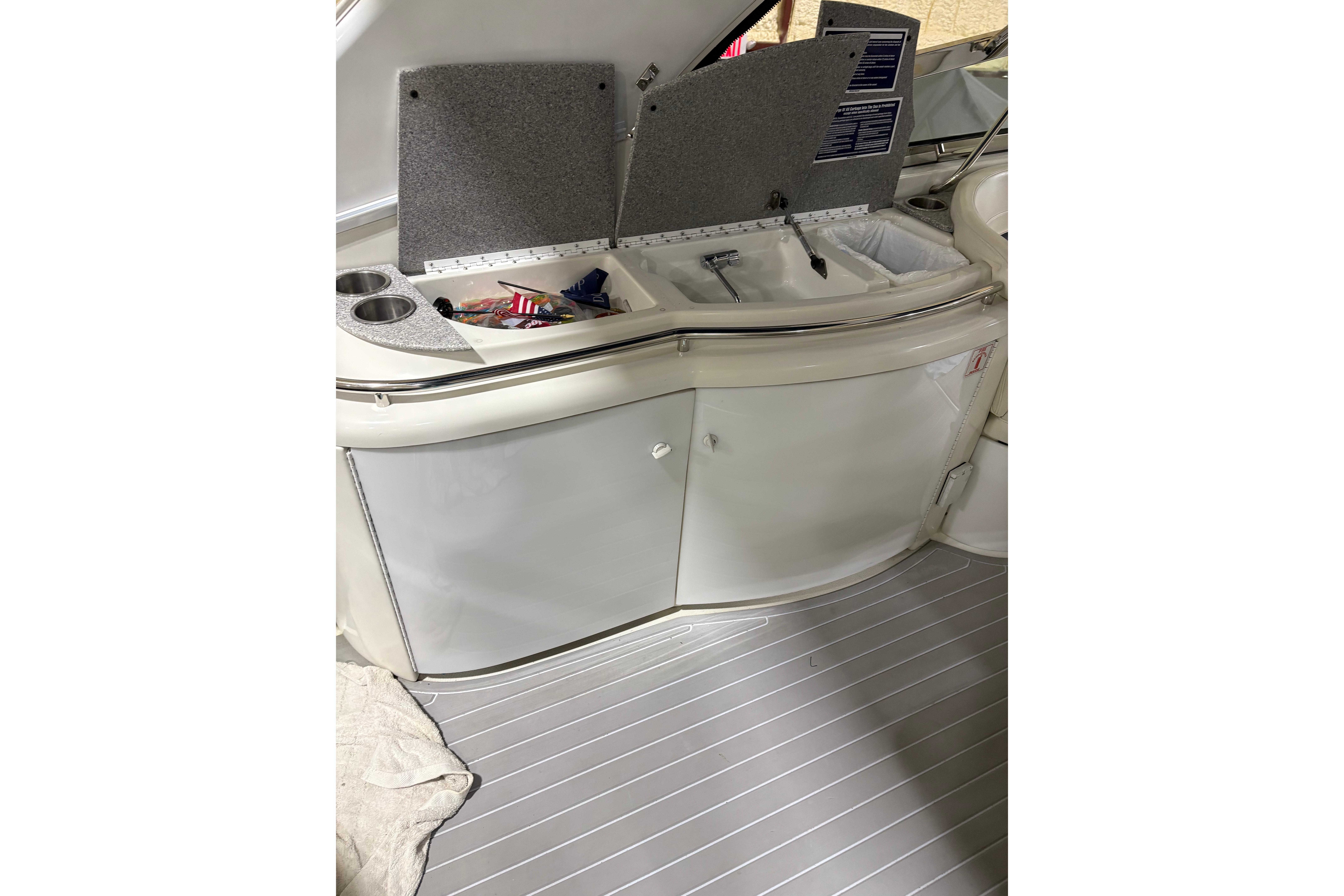 2004 Formula 400 Super Sport boat interior with open storage compartment and cup holders.