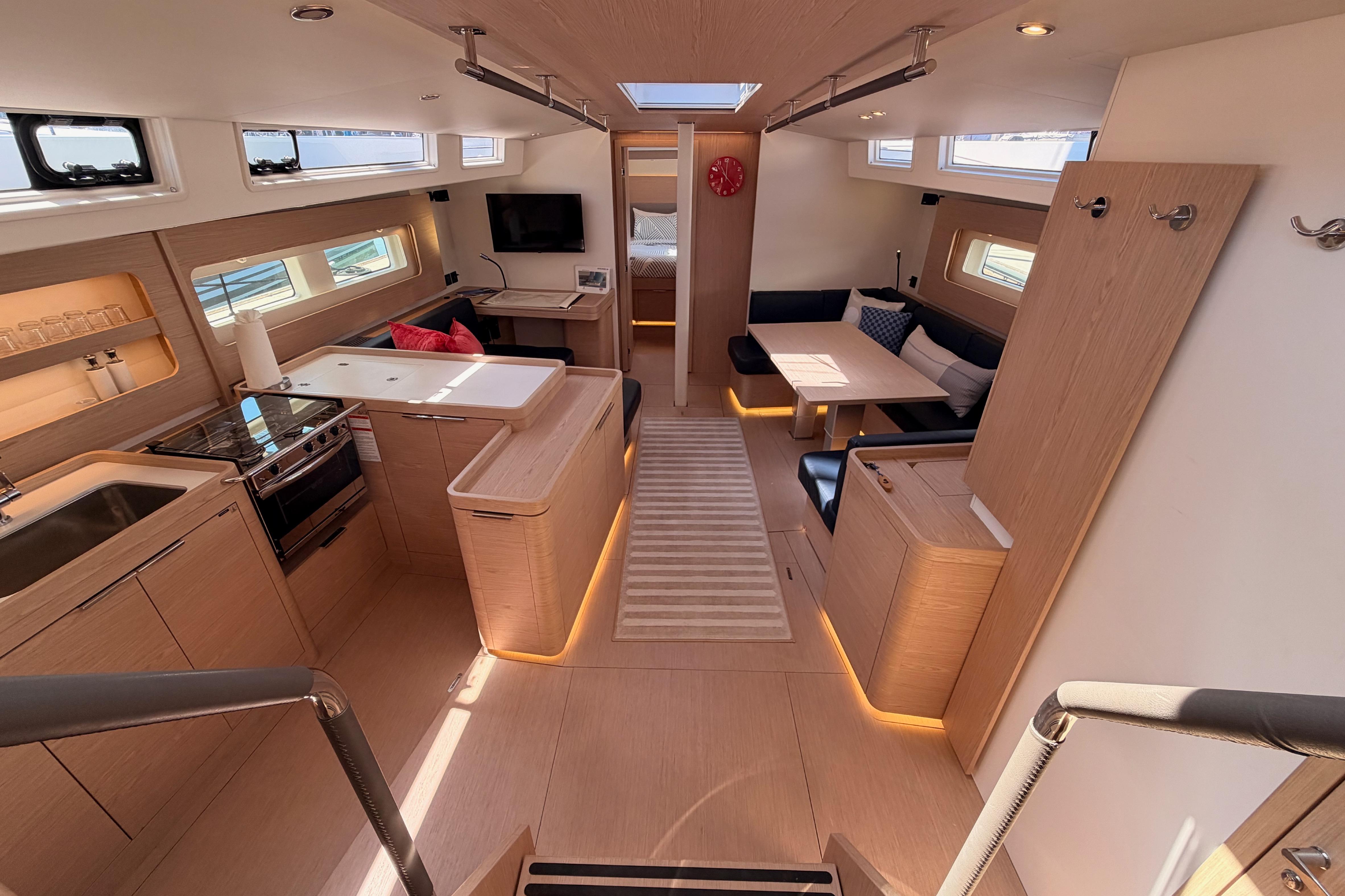 Luxurious interior of 2022 Beneteau Oceanis Yacht 54, featuring modern kitchen and seating area.