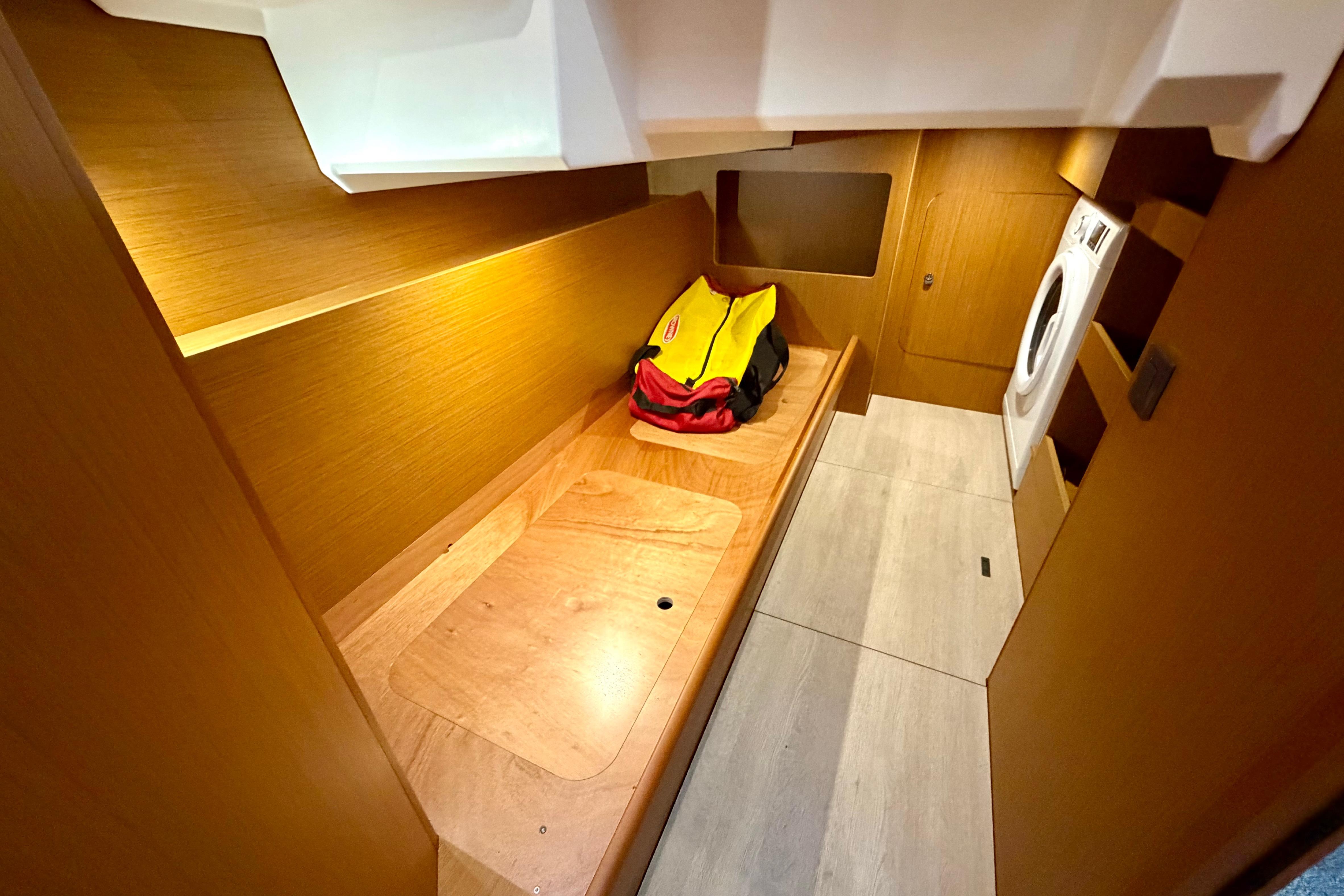 2025 Beneteau Swift Trawler 41 Fly interior with wooden finish and laundry area.