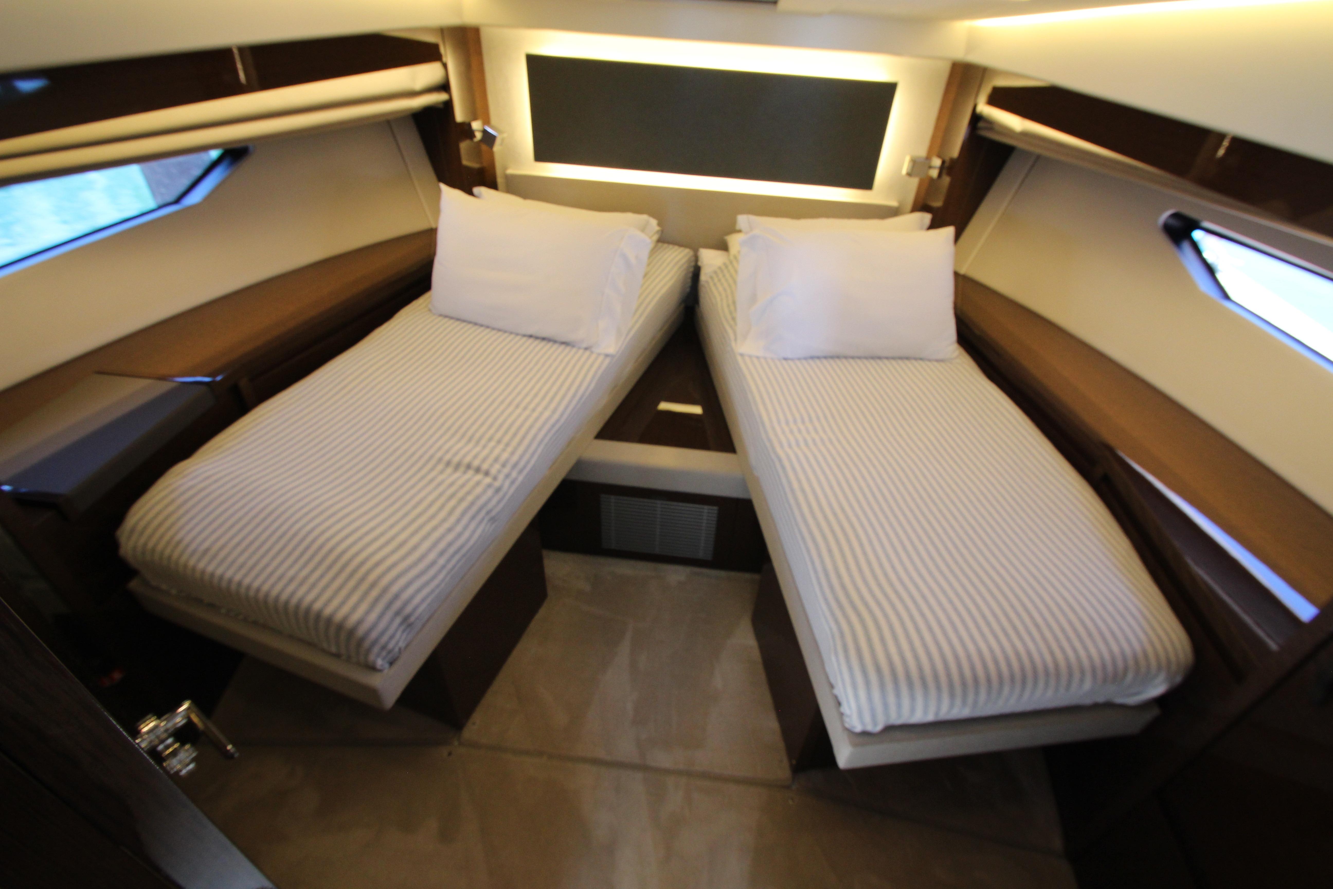 Luxurious twin cabin interior of 2022 Prestige 520 yacht with modern design.