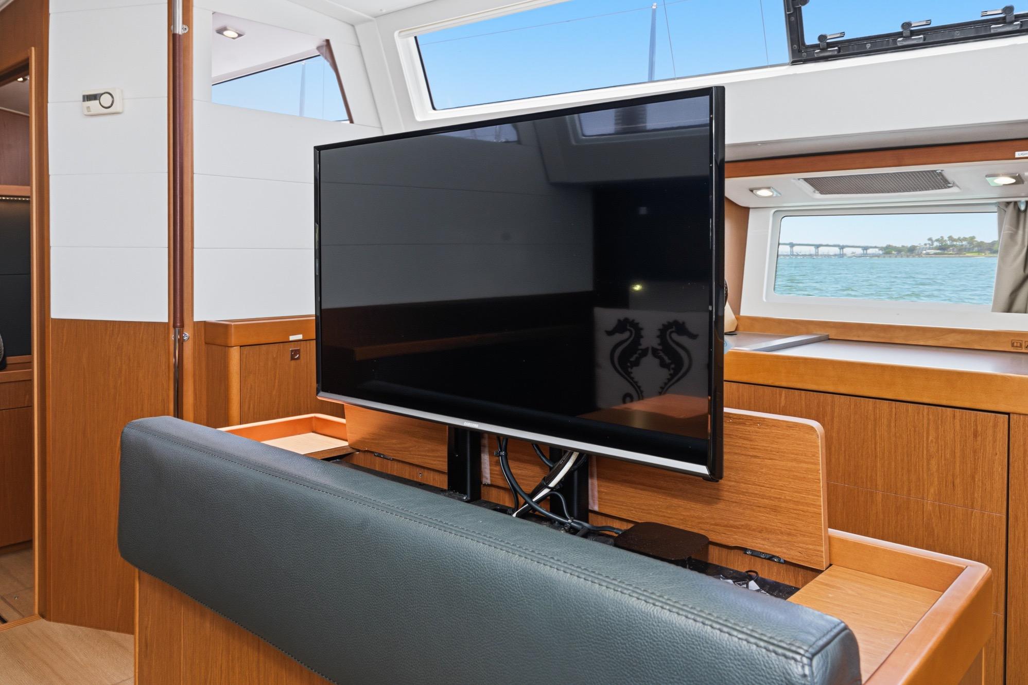 Interior of 2017 Beneteau Sense 50 yacht with TV and ocean view.
