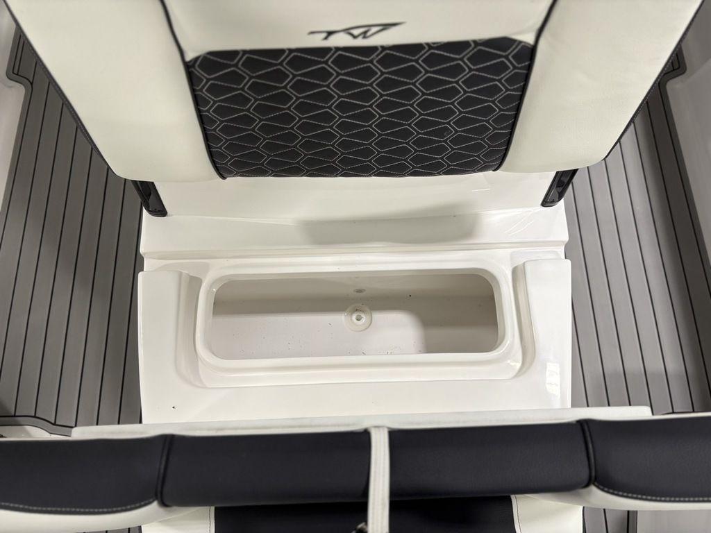 2026 Tidewater 2700 CB boat interior with storage compartment and cushioned seating.