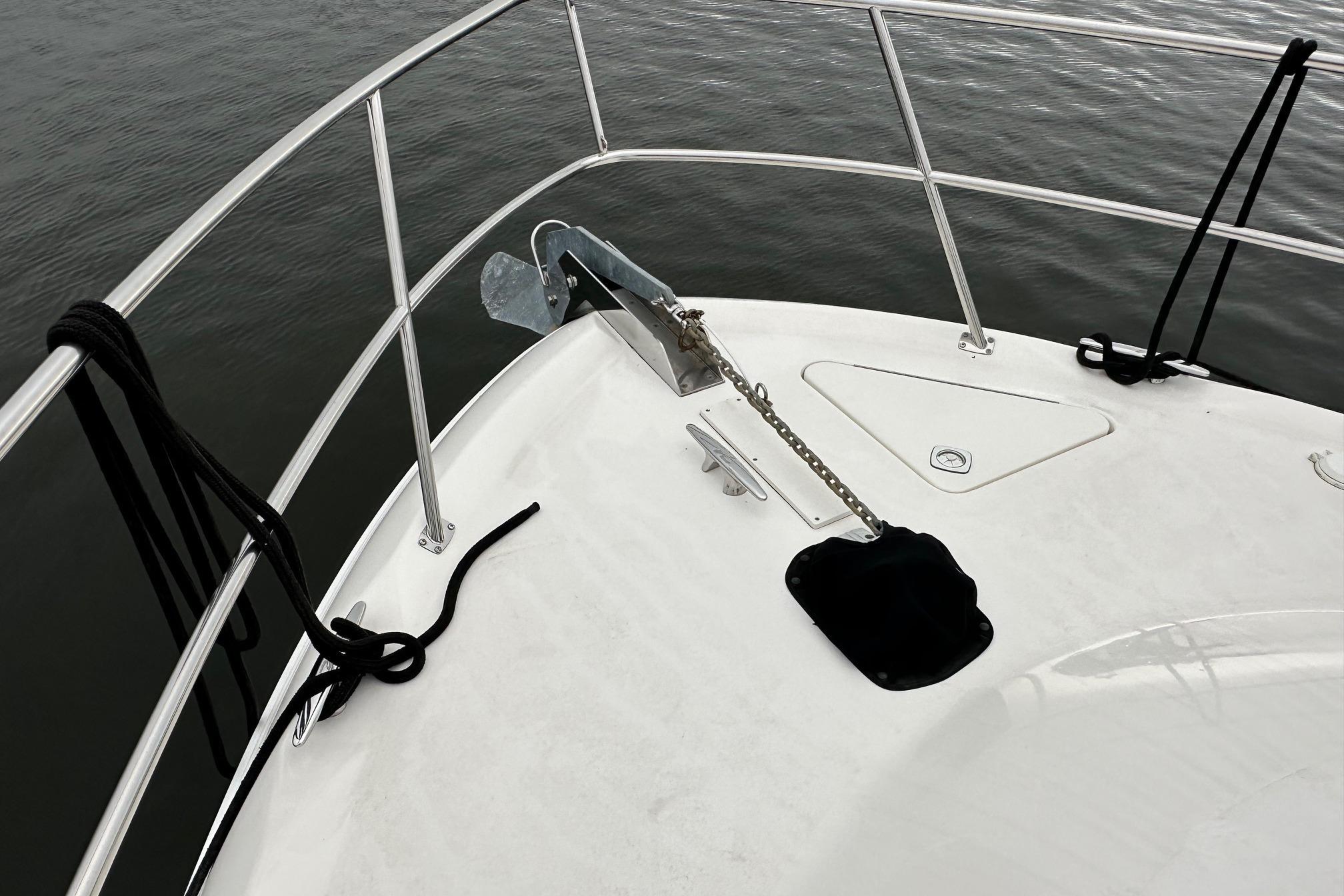 Bow of 2002 Sea Ray 400 Sedan Bridge with anchor and railing.