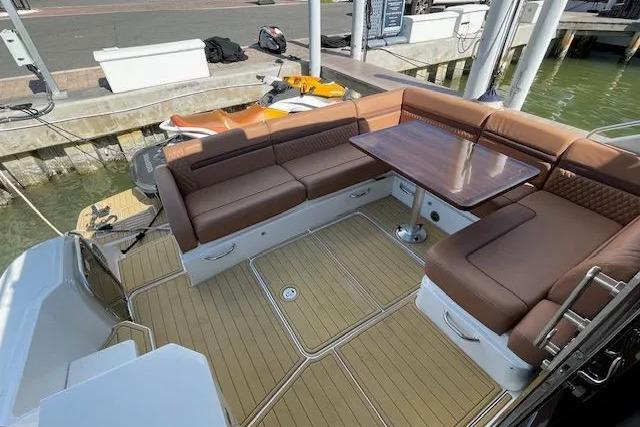 Luxurious 2016 Sea Ray Sundancer 510 yacht with elegant outdoor seating and table.