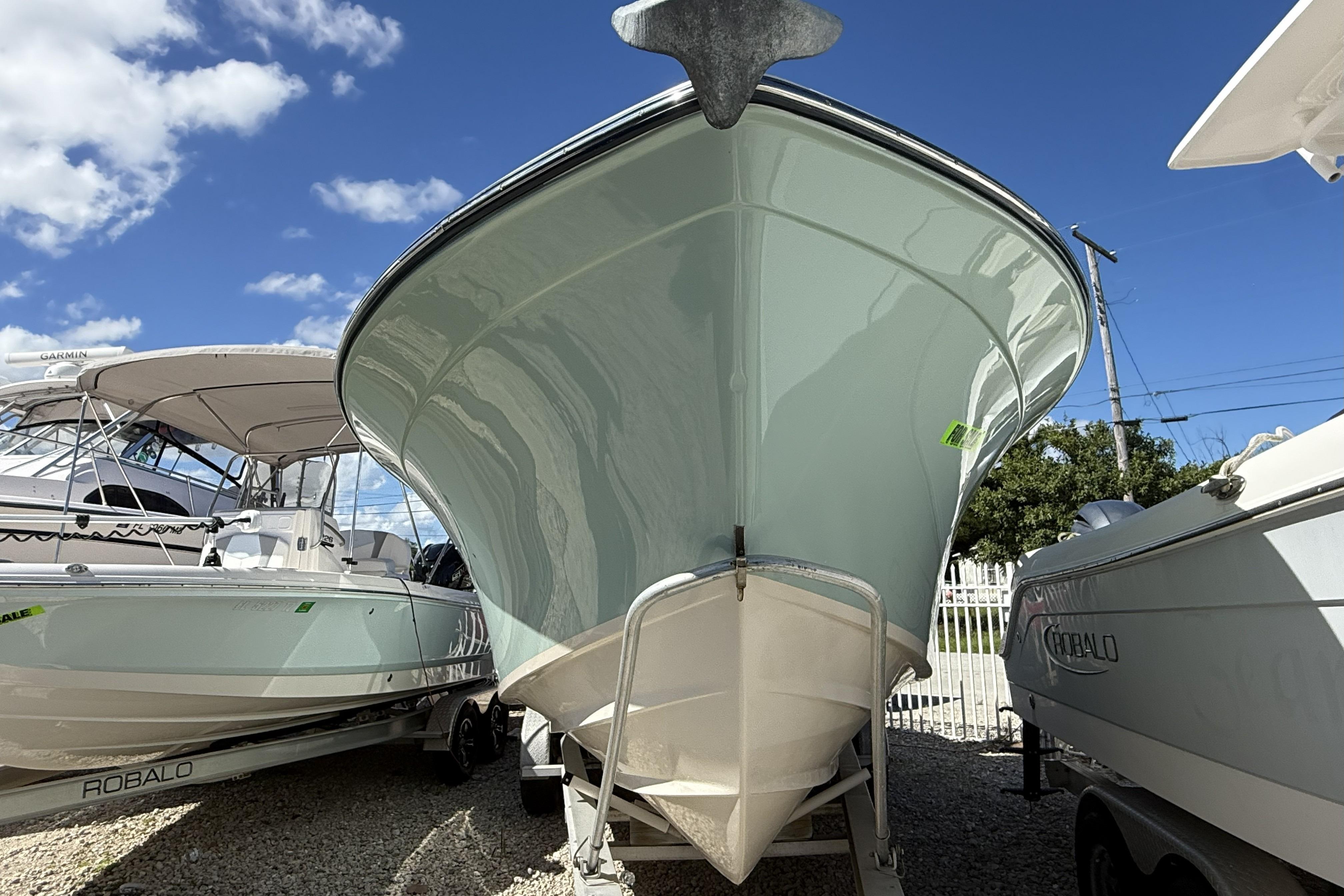 2014 Grady-White Freedom 275 boat on trailer under clear blue sky.