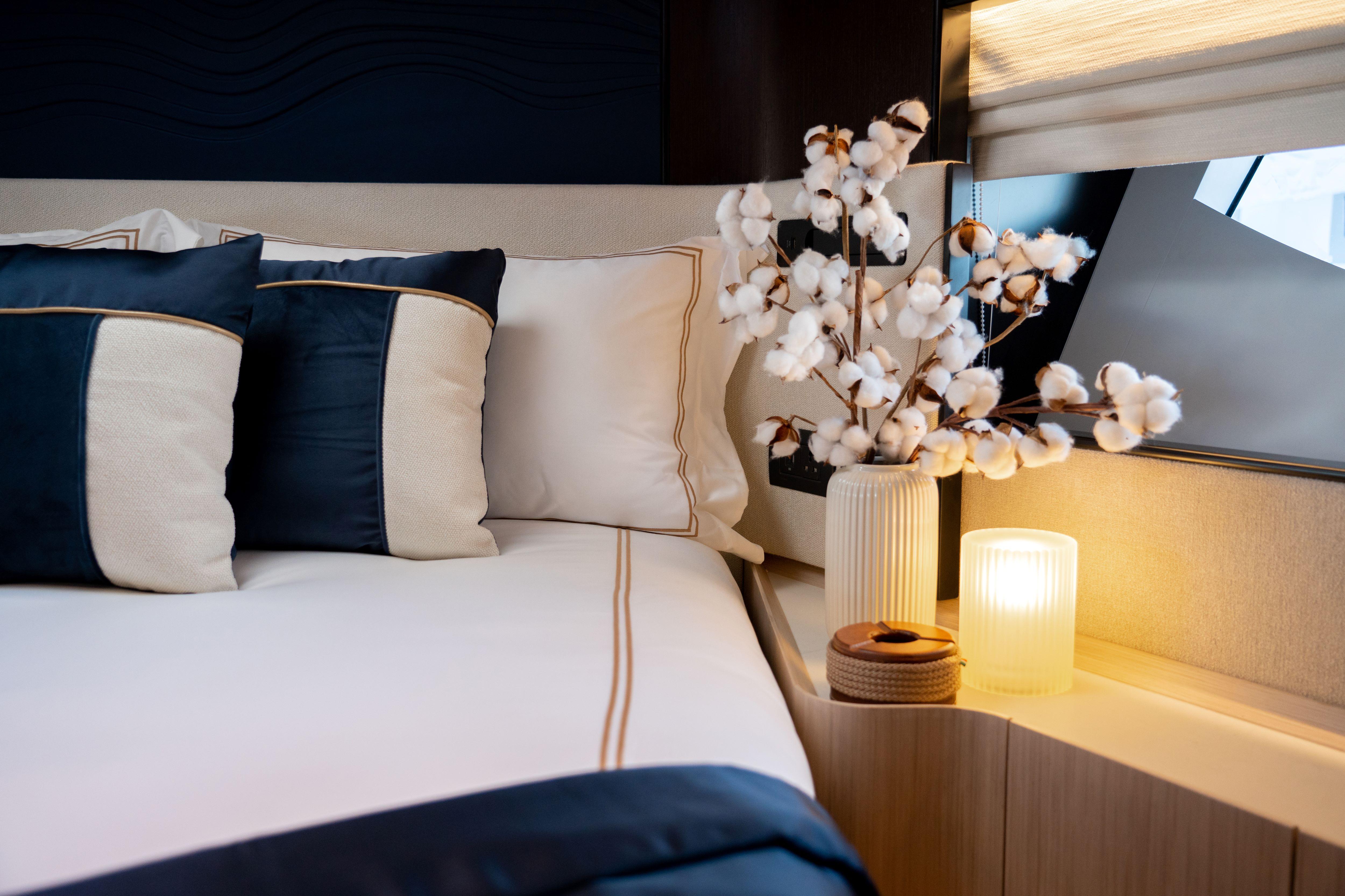 Luxurious bedroom interior on 2025 Majesty 72 yacht with elegant decor and soft lighting.