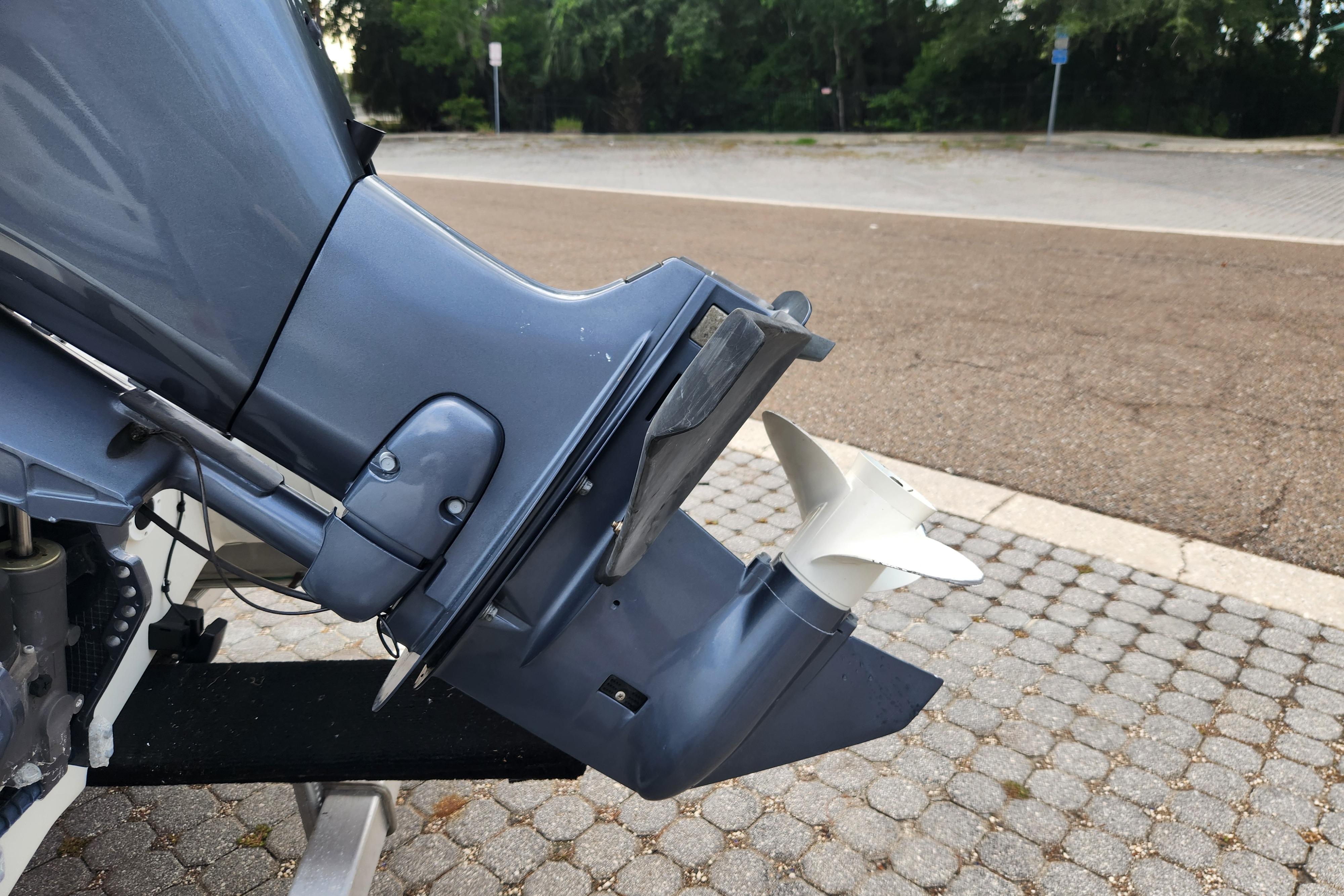 Outboard motor of a 2019 Novurania DL 400 boat on a paved surface.