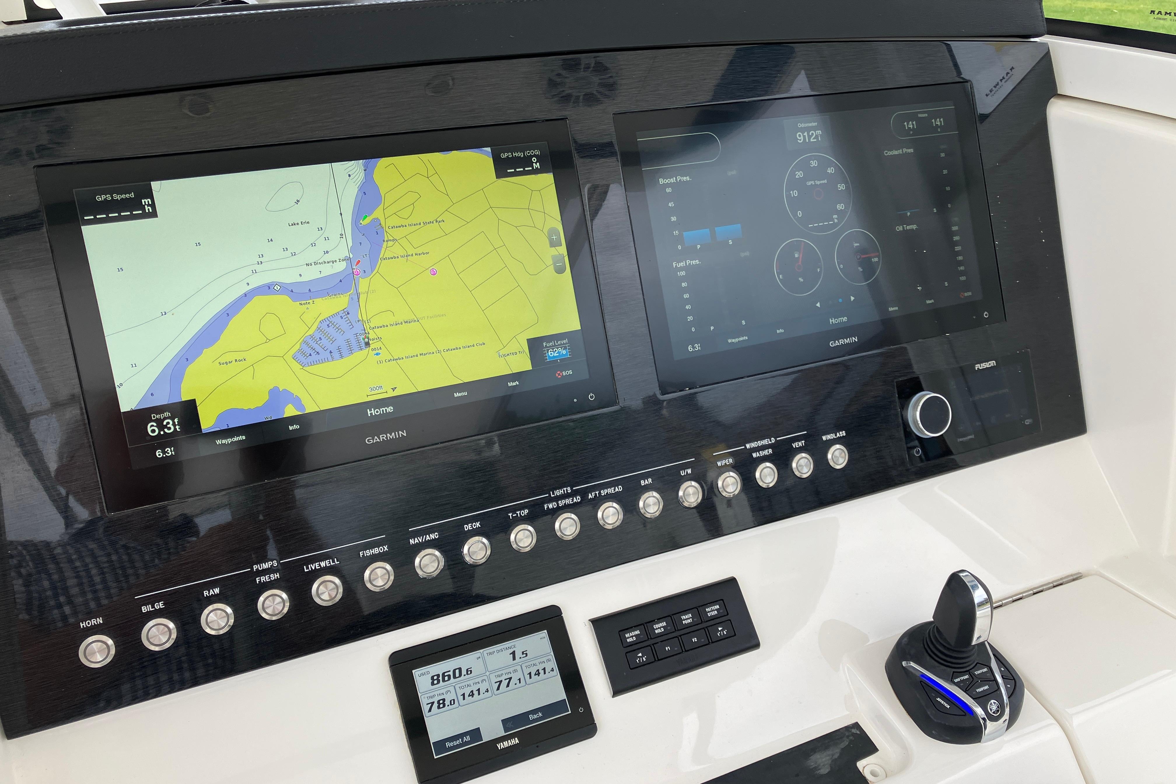 Dashboard of a 2021 Regulator 31 boat featuring Garmin navigation displays.
