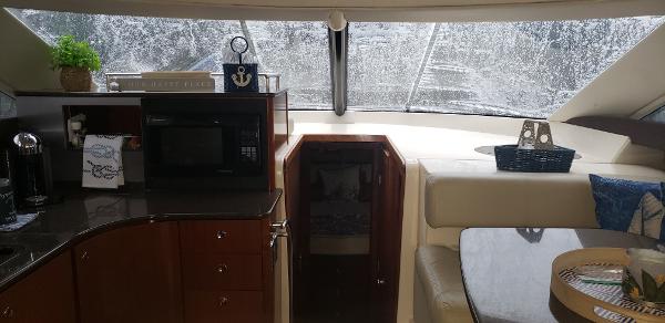 Interior of 2010 Meridian 441 Sedan yacht with kitchen and seating area.