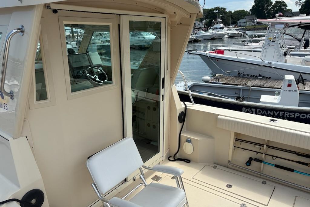 2003 Albin 28 Tournament Express boat interior with docked vessels in the background.
