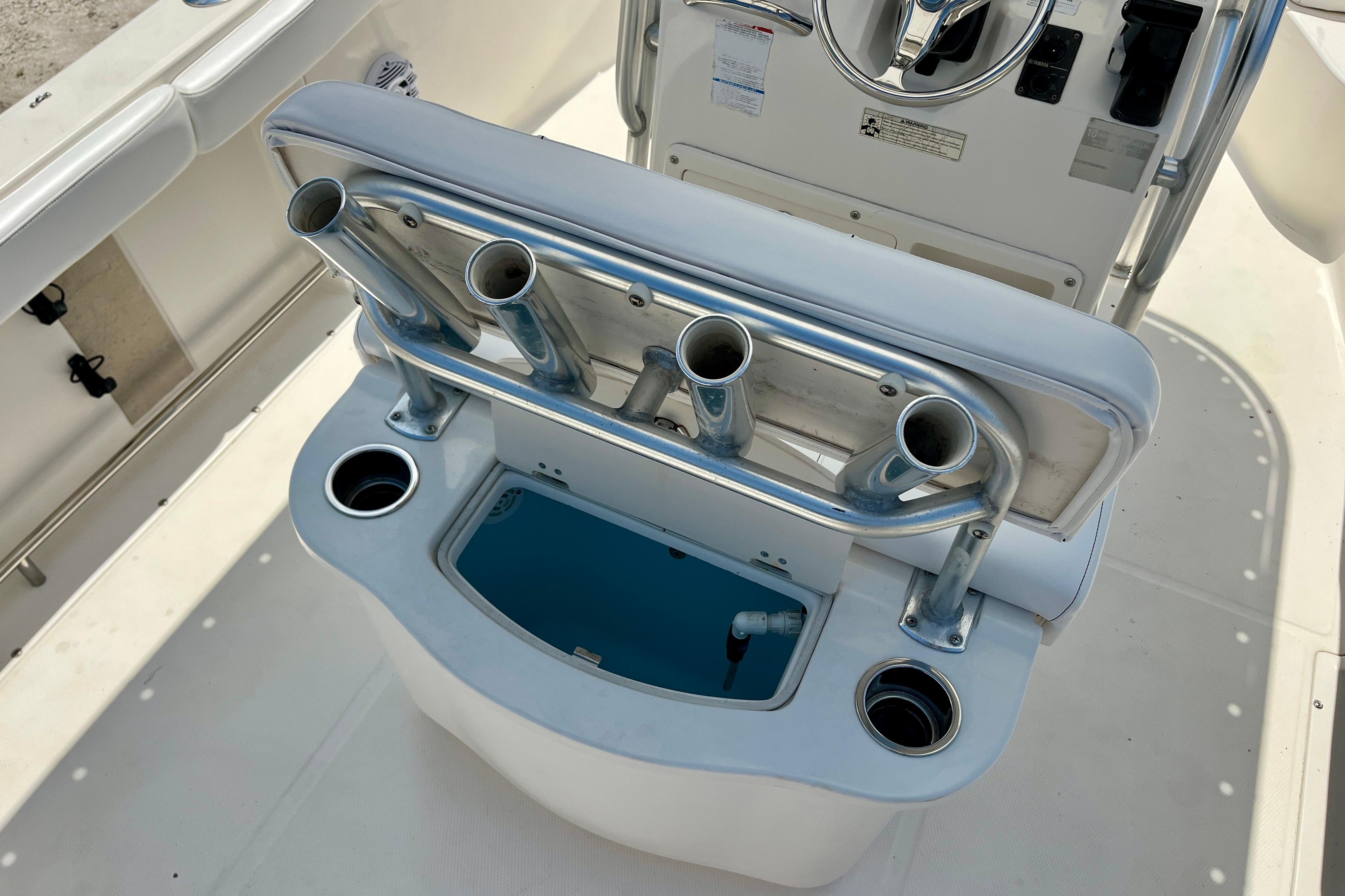 2016 Robalo R222 Center Console boat with rod holders and storage compartment.
