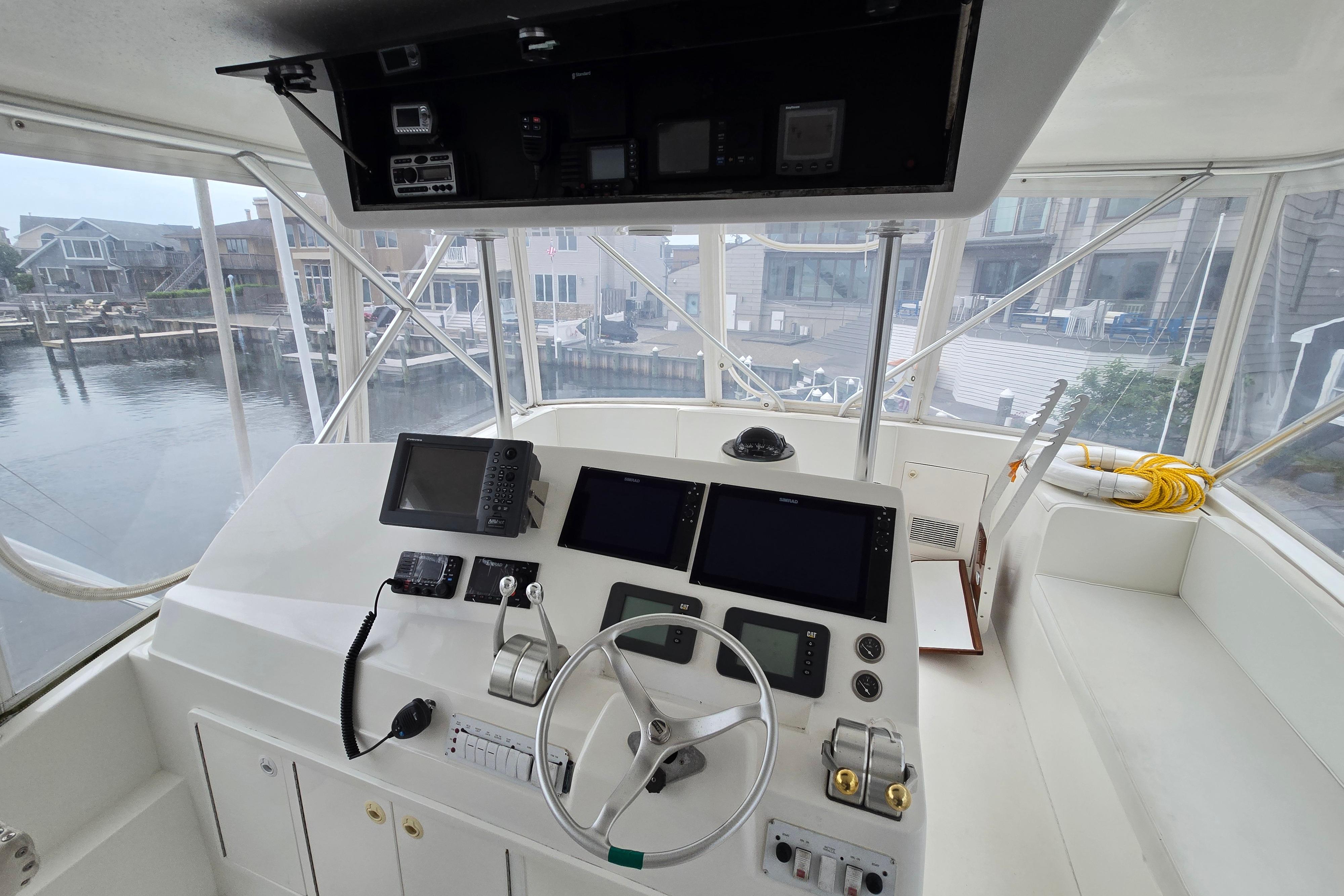 Interior view of 2001 Cavileer 53 Convertible yacht cockpit with navigation equipment.